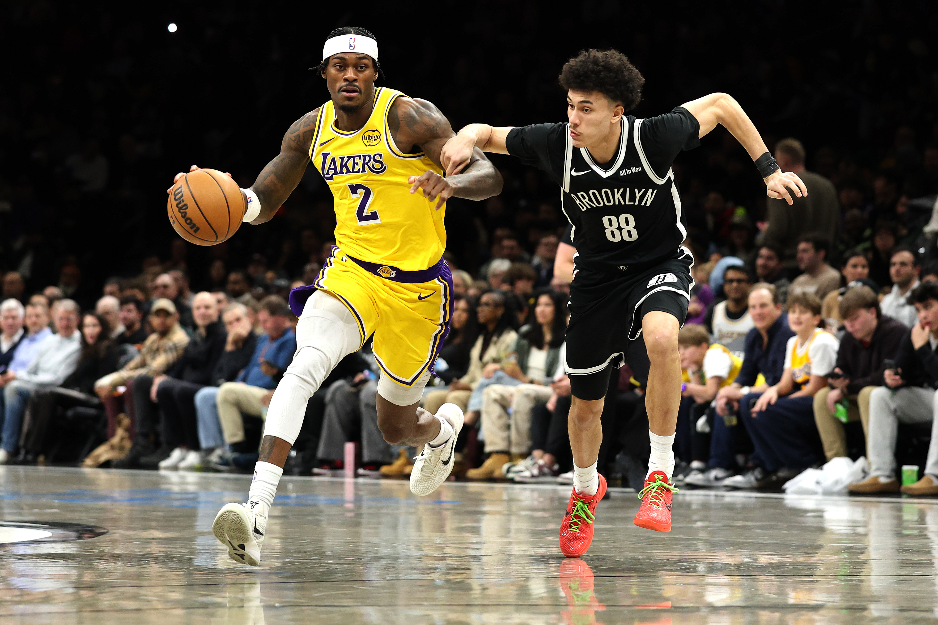 Lakers forward Jarred Vanderbilt pushes the ball up the court...