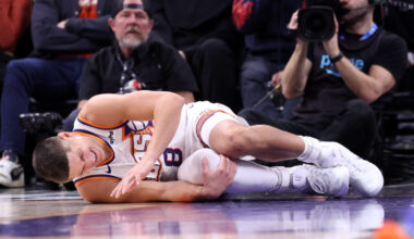 Grayson Allen #8 of the Phoenix Suns reacts after an apparent injury during the second half against...