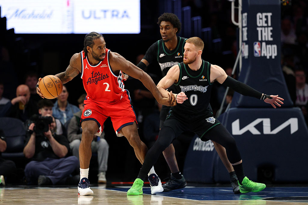 MINNEAPOLIS, MINNESOTA - FEBRUARY 08: Kawhi Leonard #2 of the Los Angeles Clippers goes to the basket against Donte DiVincenzo #0 and Jaden McDaniels #3 of the Minnesota Timberwolves in the third quarter at Target Center on February 08, 2026 in Minneapolis, Minnesota. The Clippers defeated the Timberwolves 115-96.
