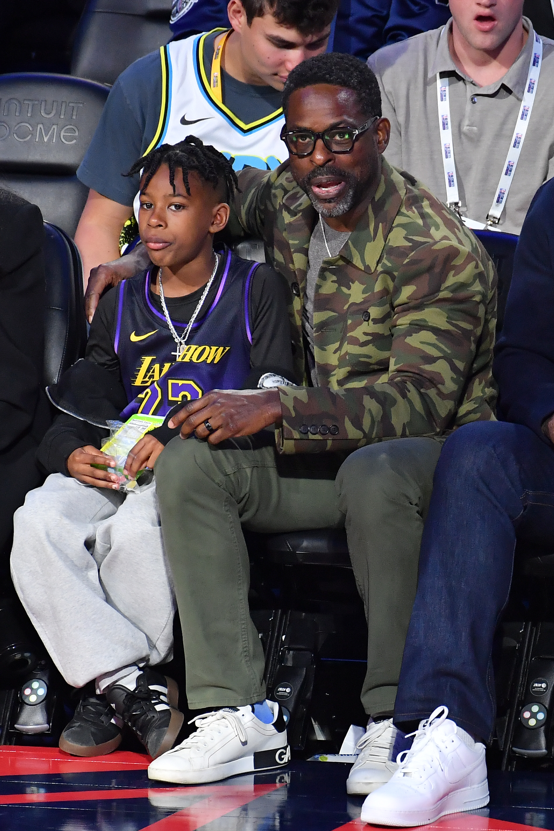 Actor Sterling K. Brown watches from a courtside seat during...