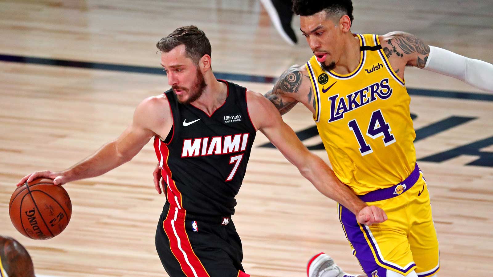 Miami Heat guard Goran Dragic (7) handles the ball against Los Angeles Lakers guard Danny Green (14) during the first quarter in game one of the 2020 NBA Finals at AdventHealth Arena. 