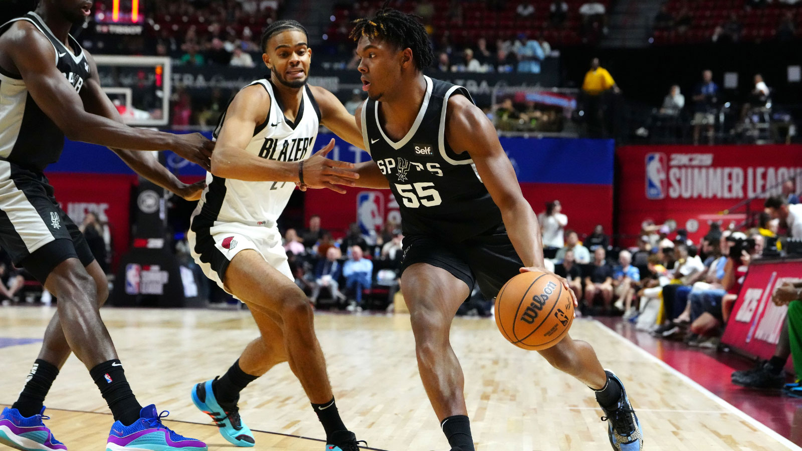 San Antonio Spurs forward Harrison Ingram (55) dribbles around Portland Trail Blazers guard Rayan Rupert (21) during the first quarter at Thomas & Mack Center.