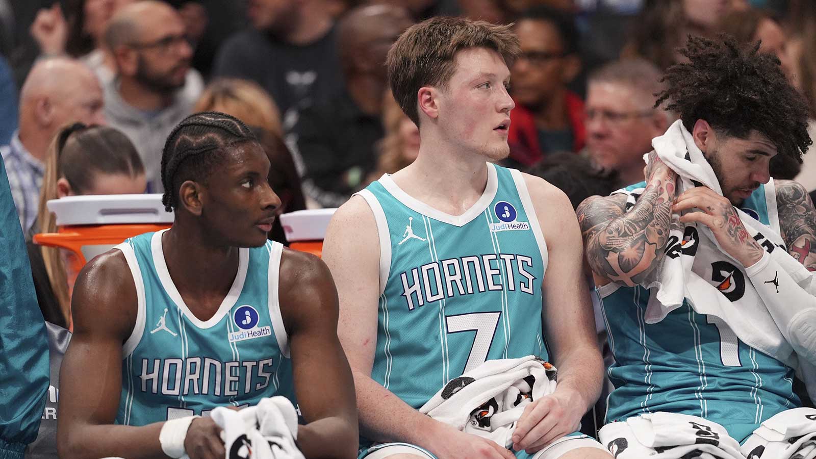 Charlotte Hornets forward Moussa Diabaté (14) and guard/forward Kon Knueppel (7) and guard LaMelo Ball (1) get a break during the second quarter against the Detroit Pistons at Spectrum Center.