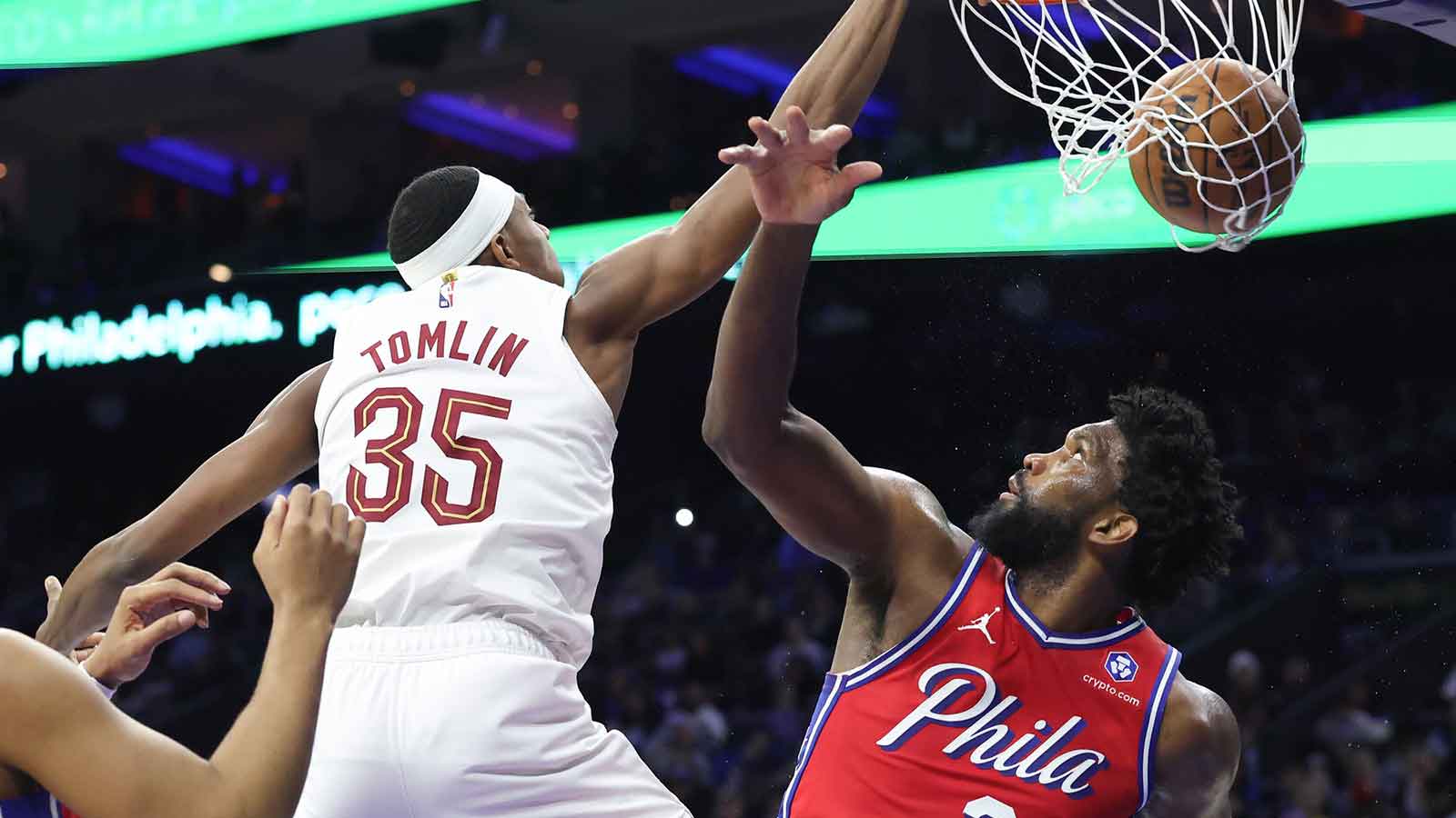 Cleveland Cavaliers forward Nae'qwan Tomlin (35) dunks the ball over Philadelphia 76ers center Joel Embiid (21) during the third quarter at Xfinity Mobile Arena. 