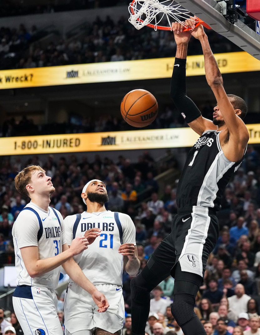 San Antonio Spurs forward Victor Wembanyama (1) dunks the ball past Dallas Mavericks forward...