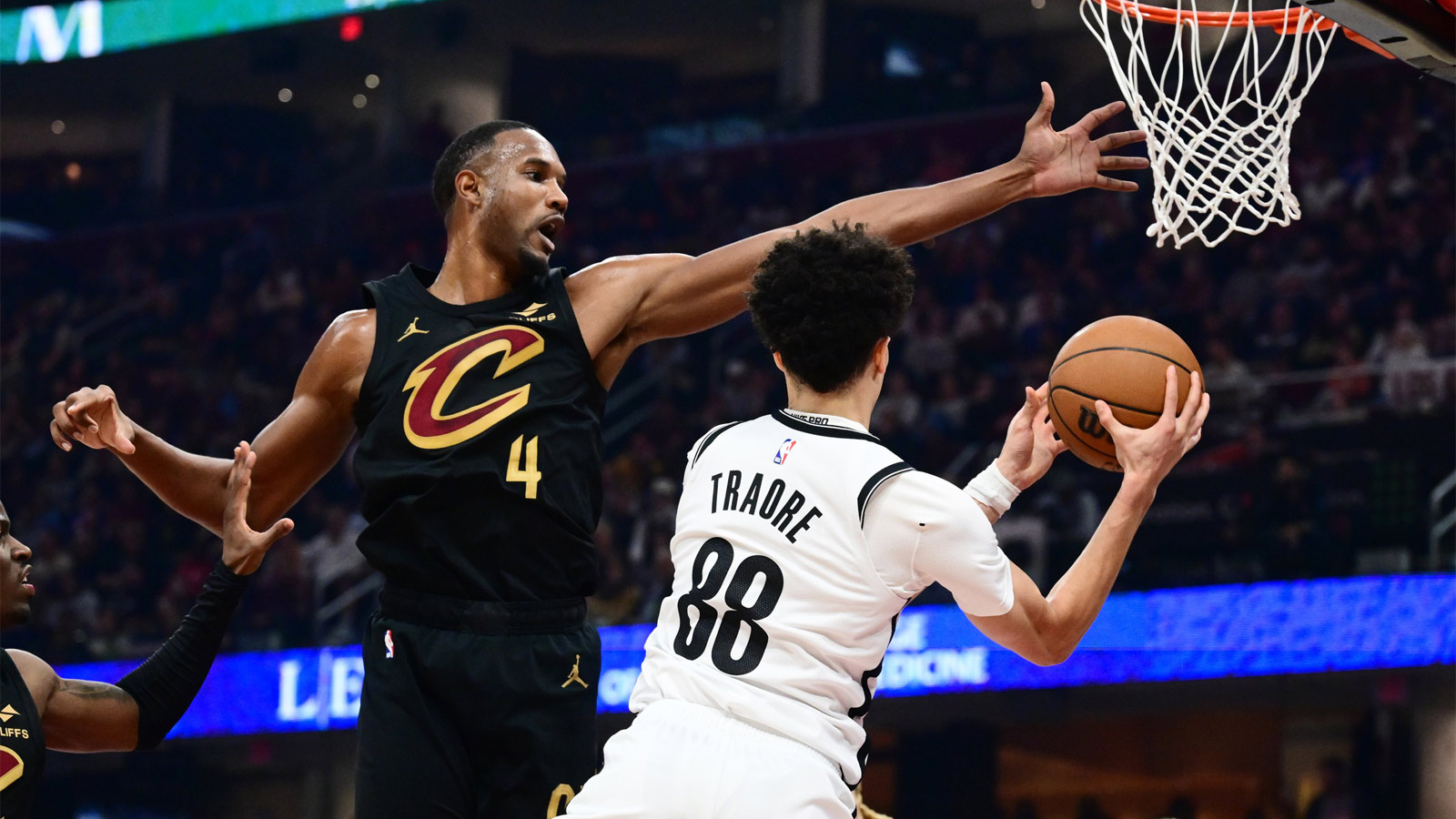 Cleveland Cavaliers center Evan Mobley (4) tries to block the pass of Brooklyn Nets guard Nolan Traore (88) during the first half at Rocket Arena.