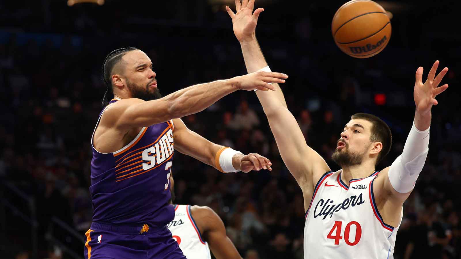Phoenix Suns forward Dillon Brooks (3) passes the ball against Los Angeles Clippers center Ivica Zubac (40) in the second half at Mortgage Matchup Center. Mandatory Credit: Mark J. Rebilas-Imagn Images