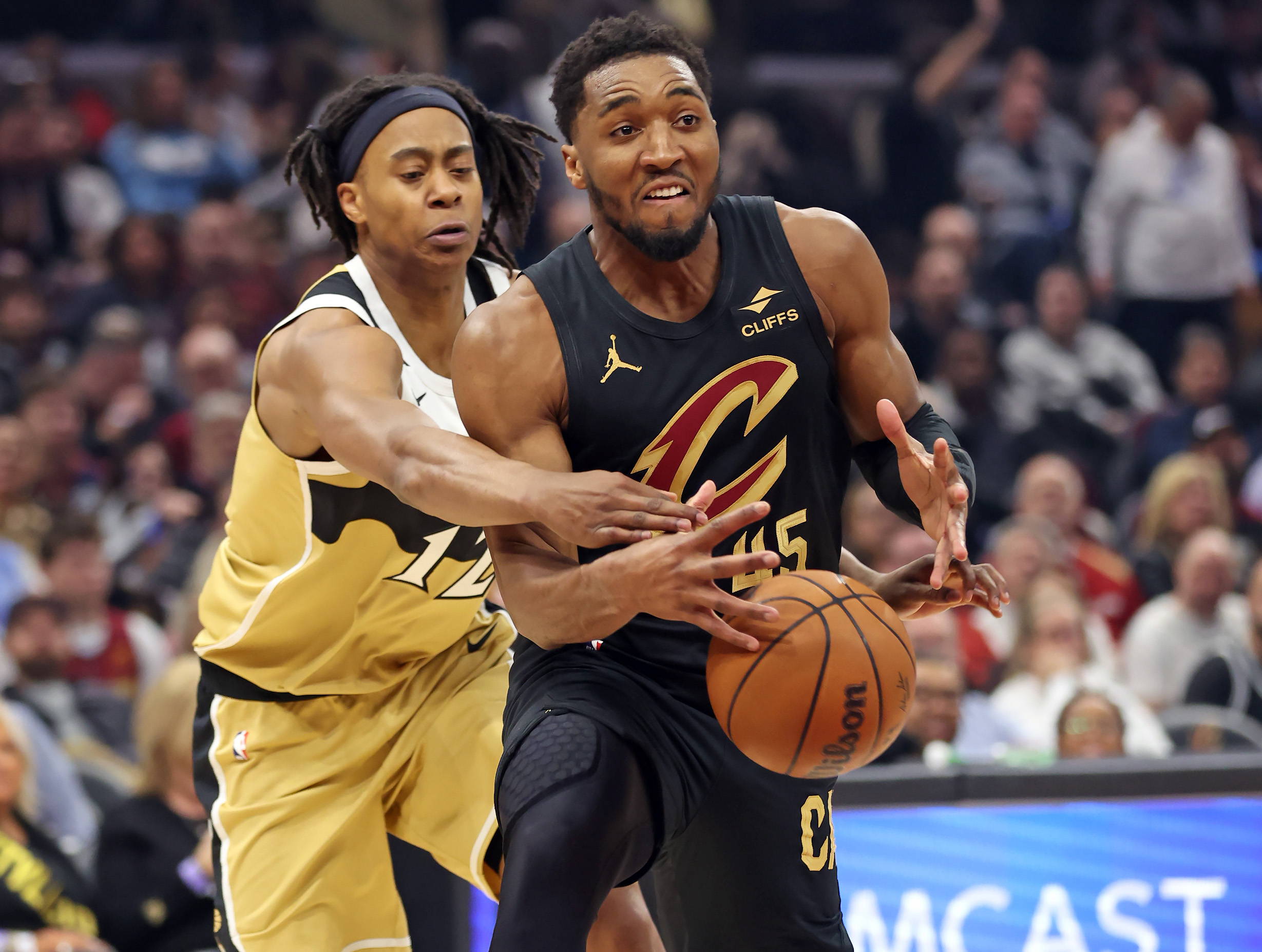 Washington Wizards guard Tre Johnson knocks the ball away from Cleveland Cavaliers guard Donovan Mitchell, fouling him in the process, in the first half of play. 