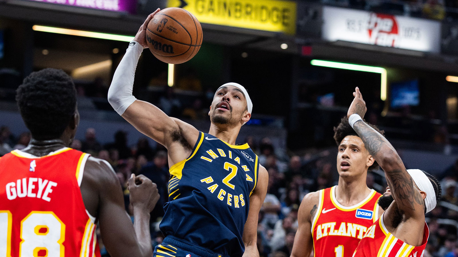 Indiana Pacers guard/forward Andrew Nembhard (2) shoots the ball while Atlanta Hawks guard Nickeil Alexander-Walker (7) defends in the first half at Gainbridge Fieldhouse.