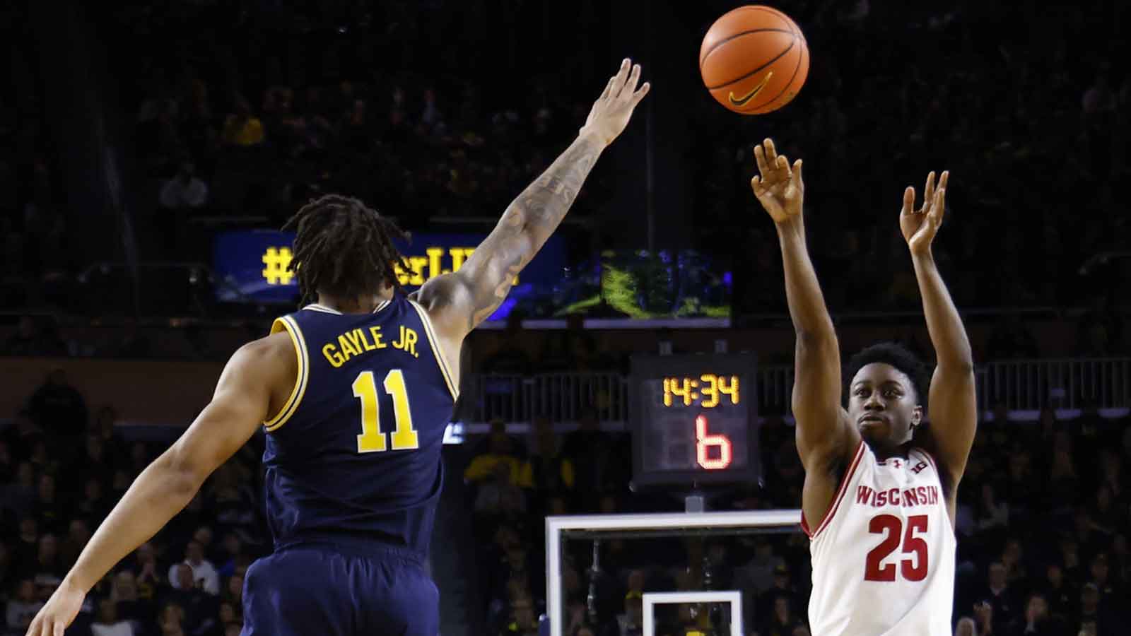 Wisconsin Badgers guard John Blackwell (25) shoots on Michigan Wolverines guard Roddy Gayle Jr. (11) in the second half at Crisler Center.