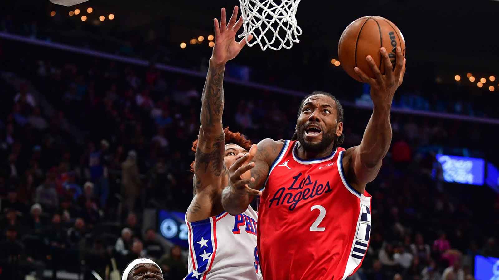 Los Angeles Clippers forward Kawhi Leonard (2) moves to the basket ahead of Philadelphia 76ers guard Kelly Oubre Jr. (9) during the first half at Intuit Dome.