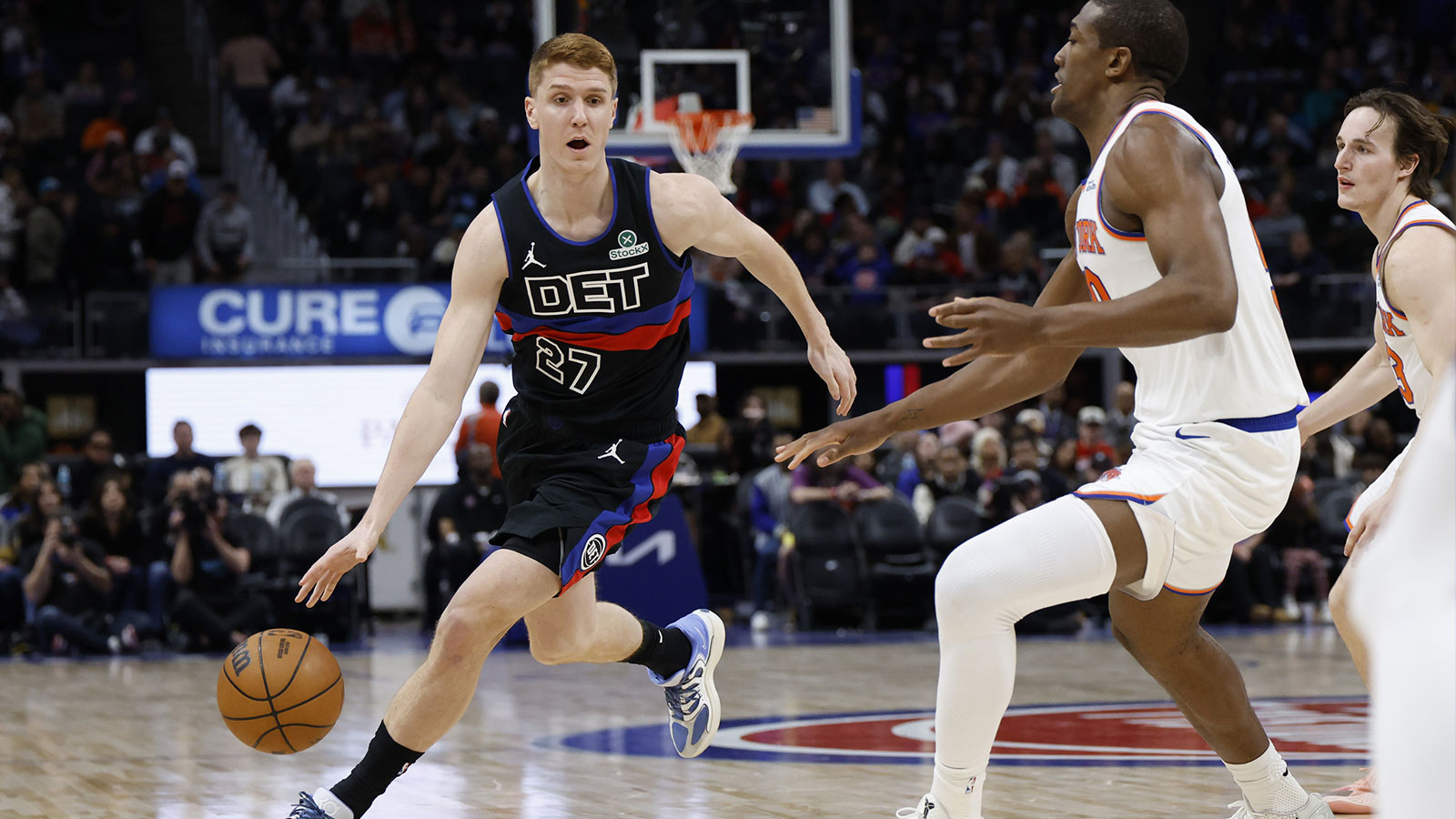 Detroit Pistons guard Kevin Huerter (27) dribbles on New York Knicks forward Trey Jemison III (50) in the second half at Little Caesars Arena.