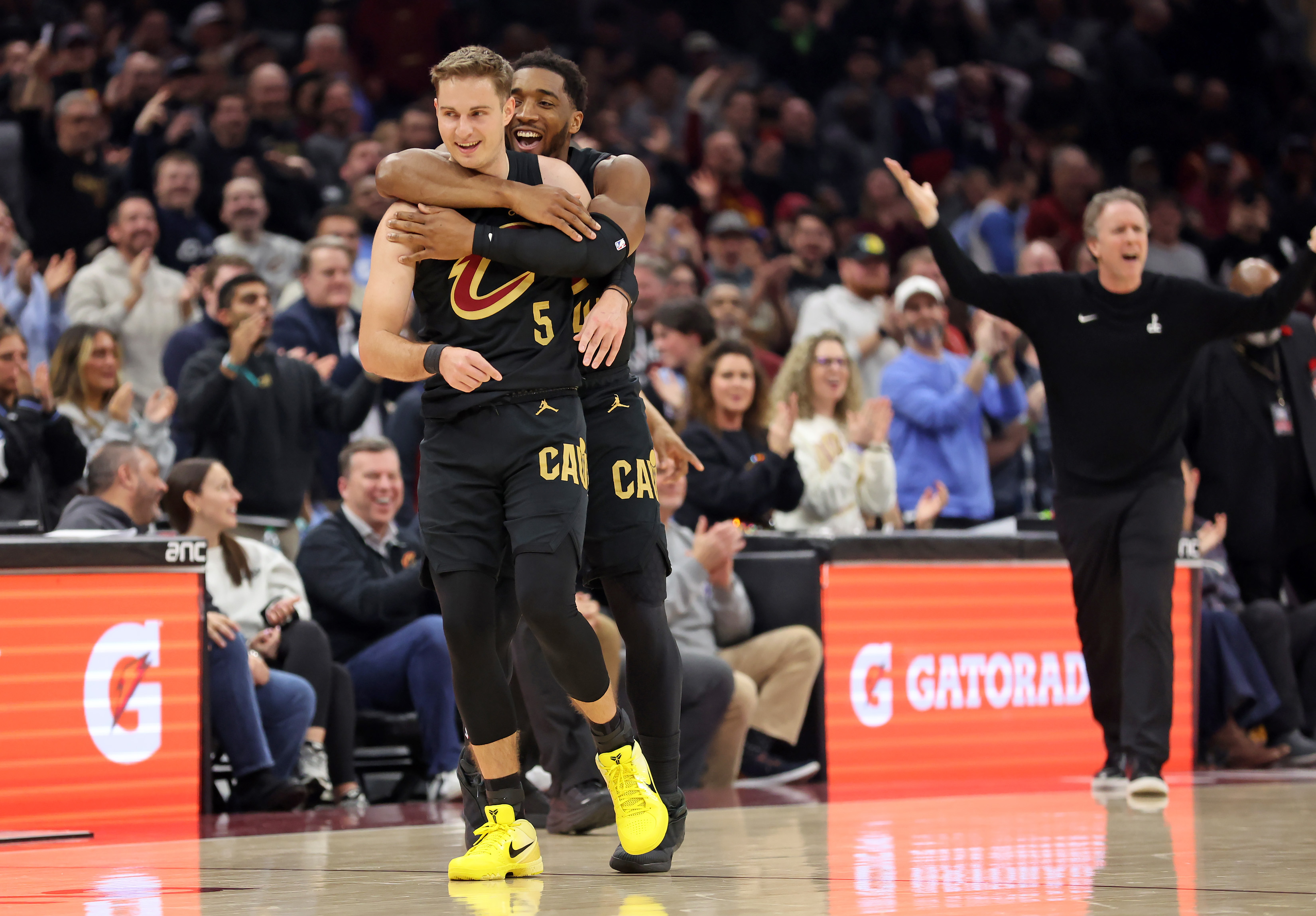 Cleveland Cavaliers guard Donovan Mitchell jumps on the back of Cleveland Cavaliers guard Sam Merrill after Merrill sank a three against the Washington Wizards in the first half of play. 