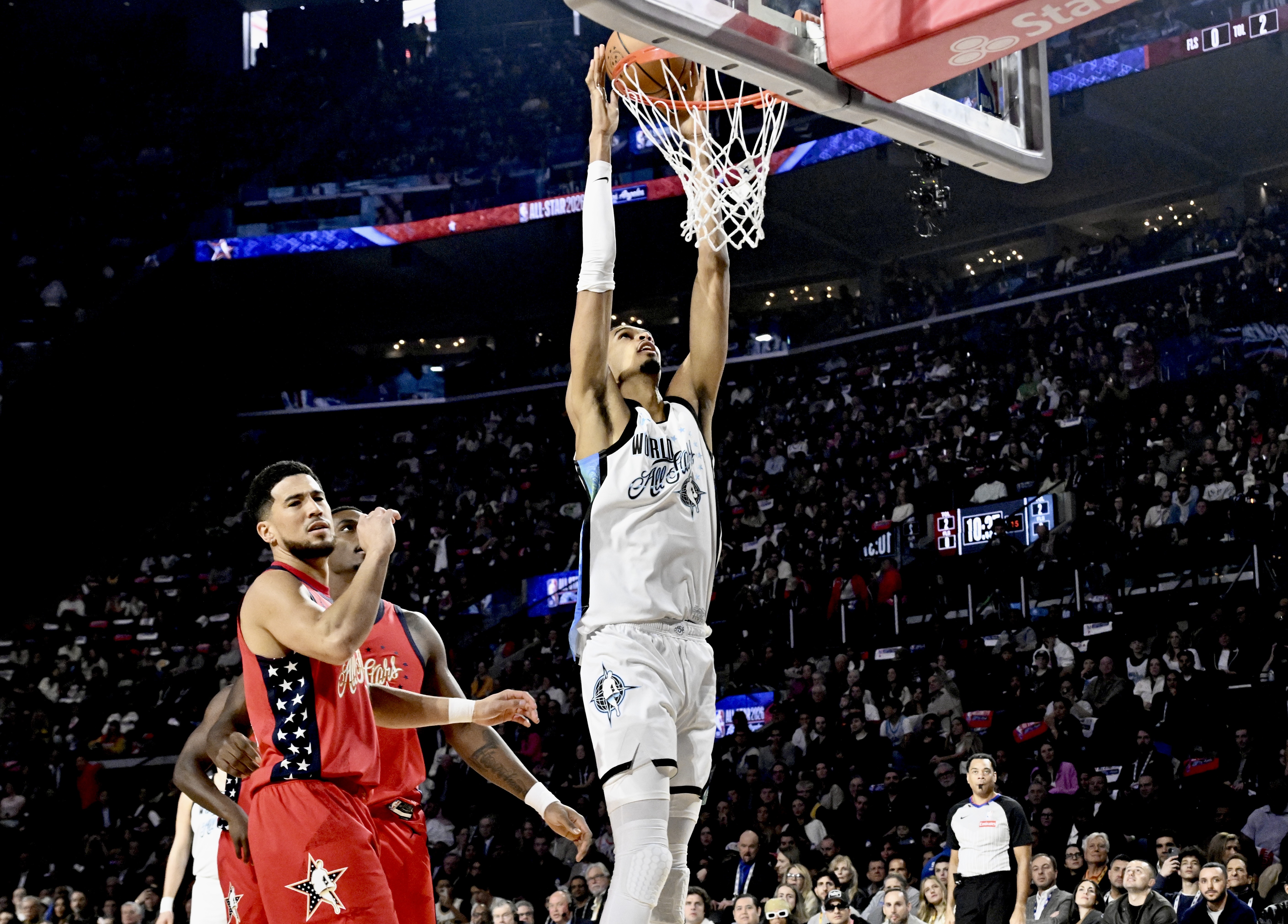 San Antonio Spurs star Victor Wembanyama of Team World lays...