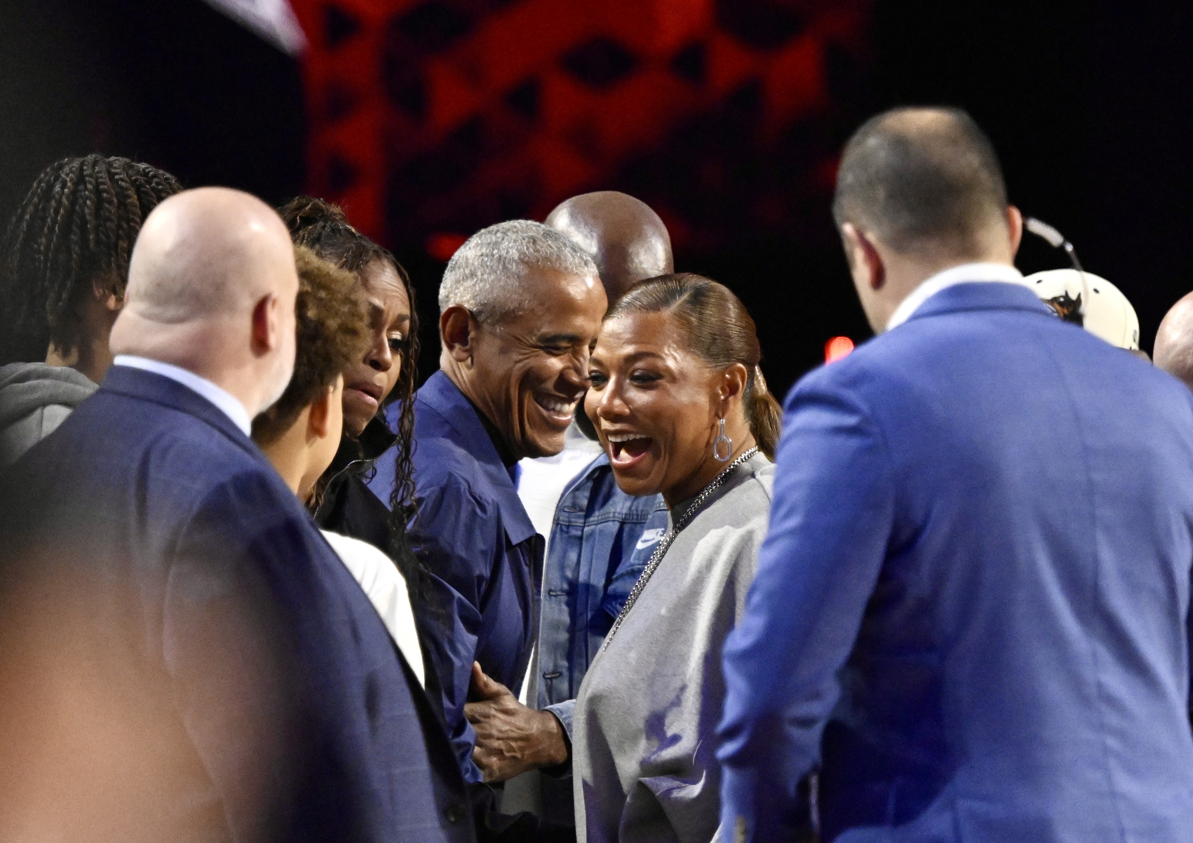 Former President Barack Obama, center, and actress/singer Queen Latifah, center,...