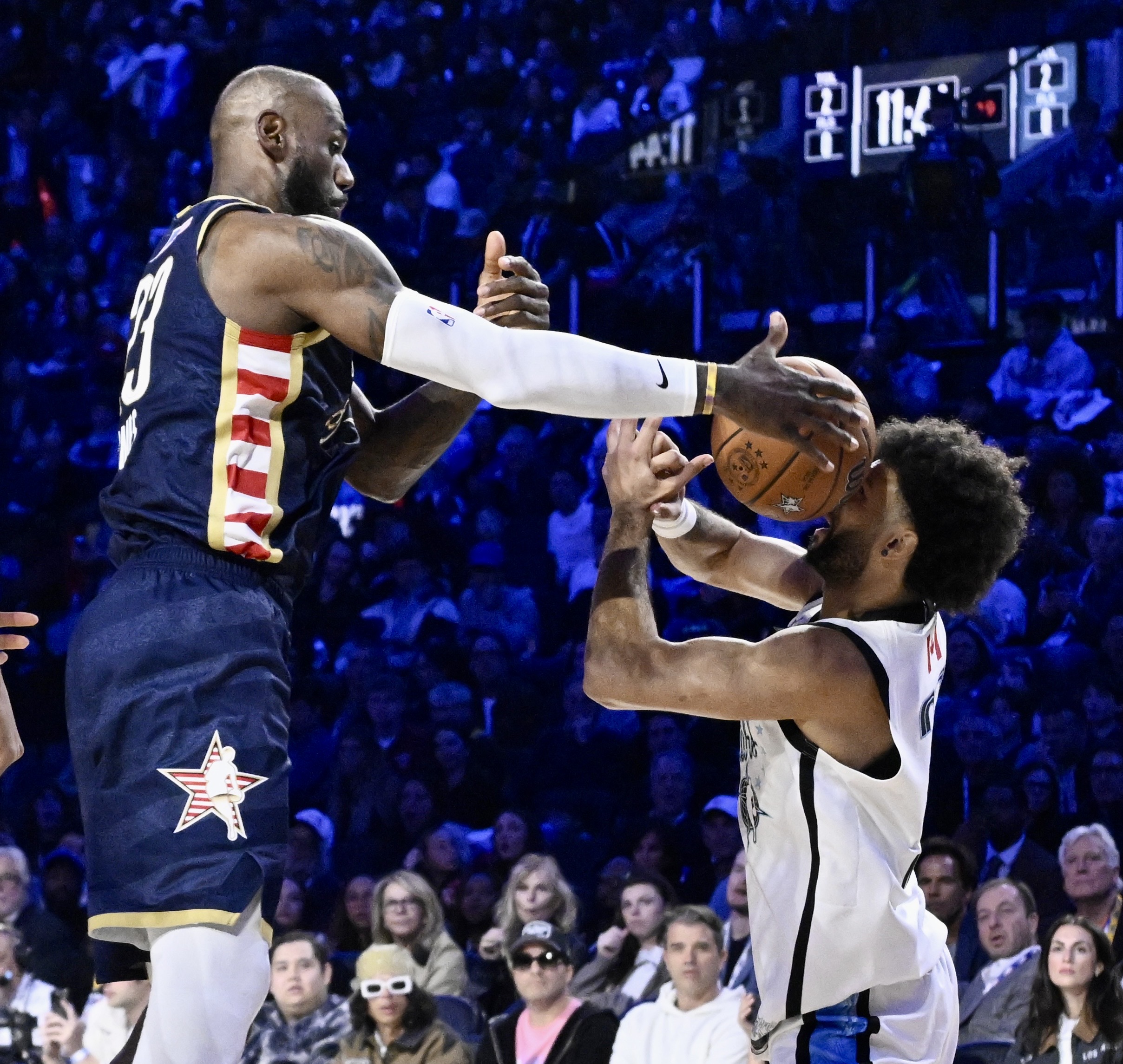 Lakers star LeBron James, left, of Team USA Stripes battles...
