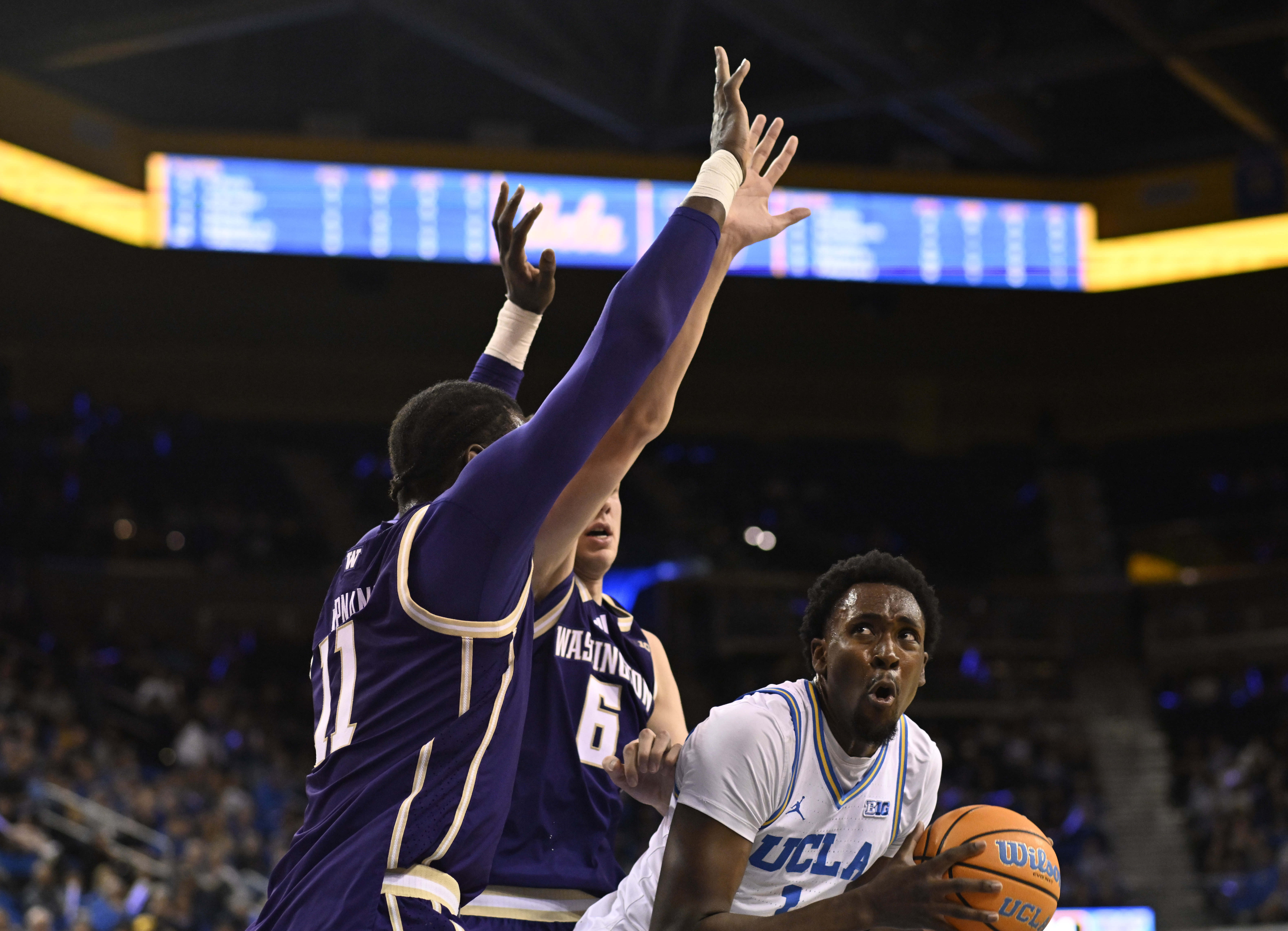 Center Xavier Booker #1 of the UCLA Bruins drives to...