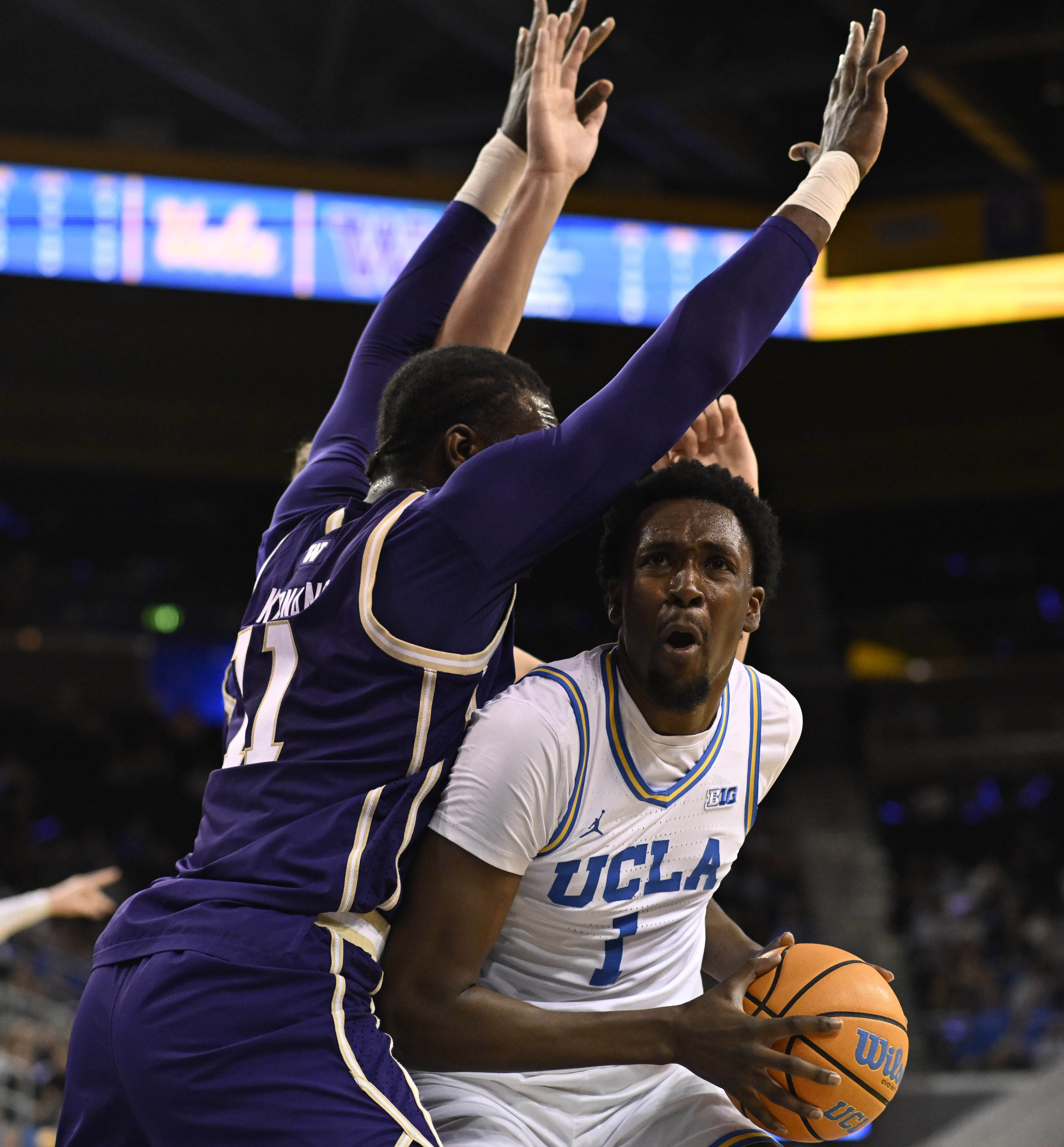 Center Xavier Booker #1 of the UCLA Bruins drives to...