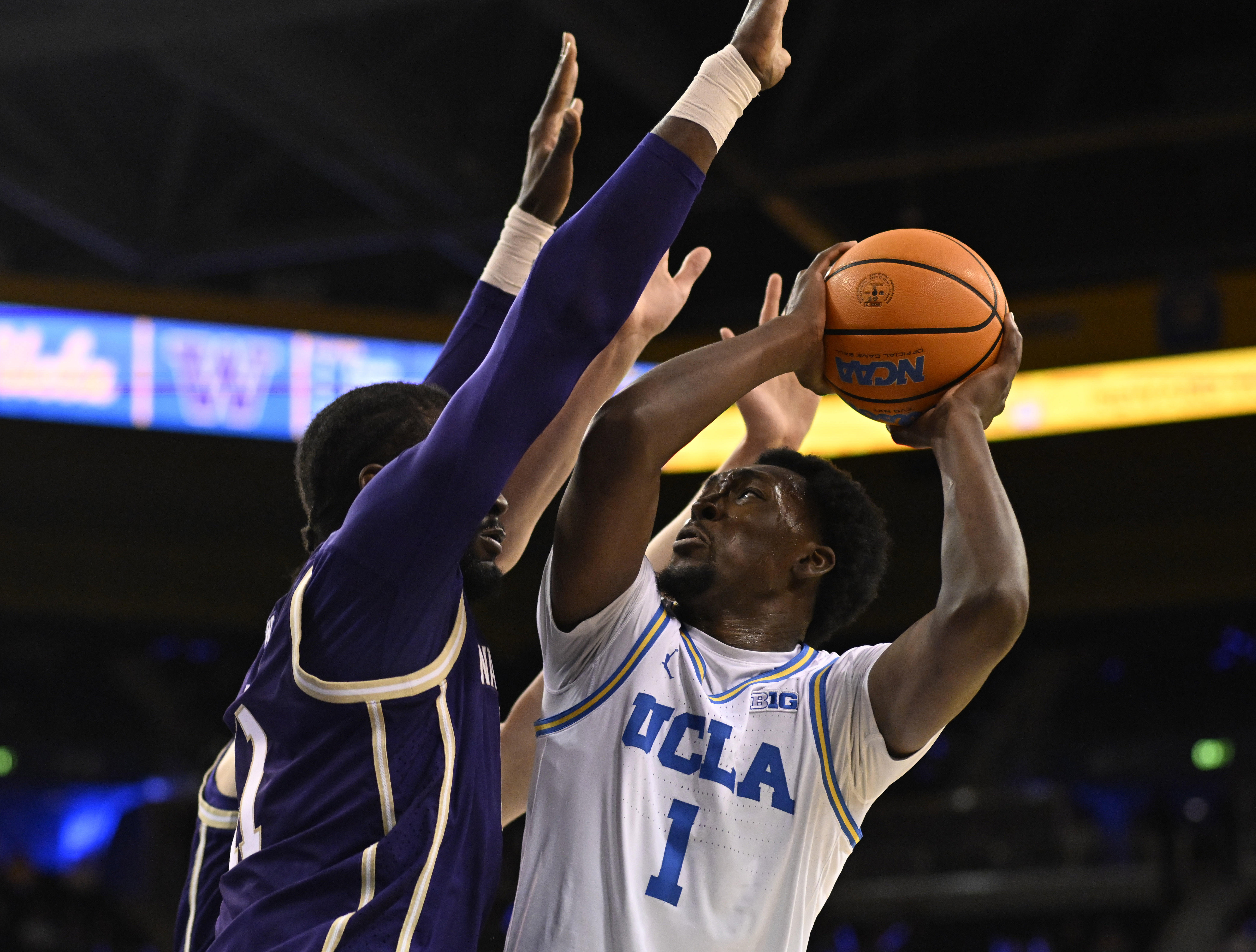 Center Xavier Booker #1 of the UCLA Bruins drives to...