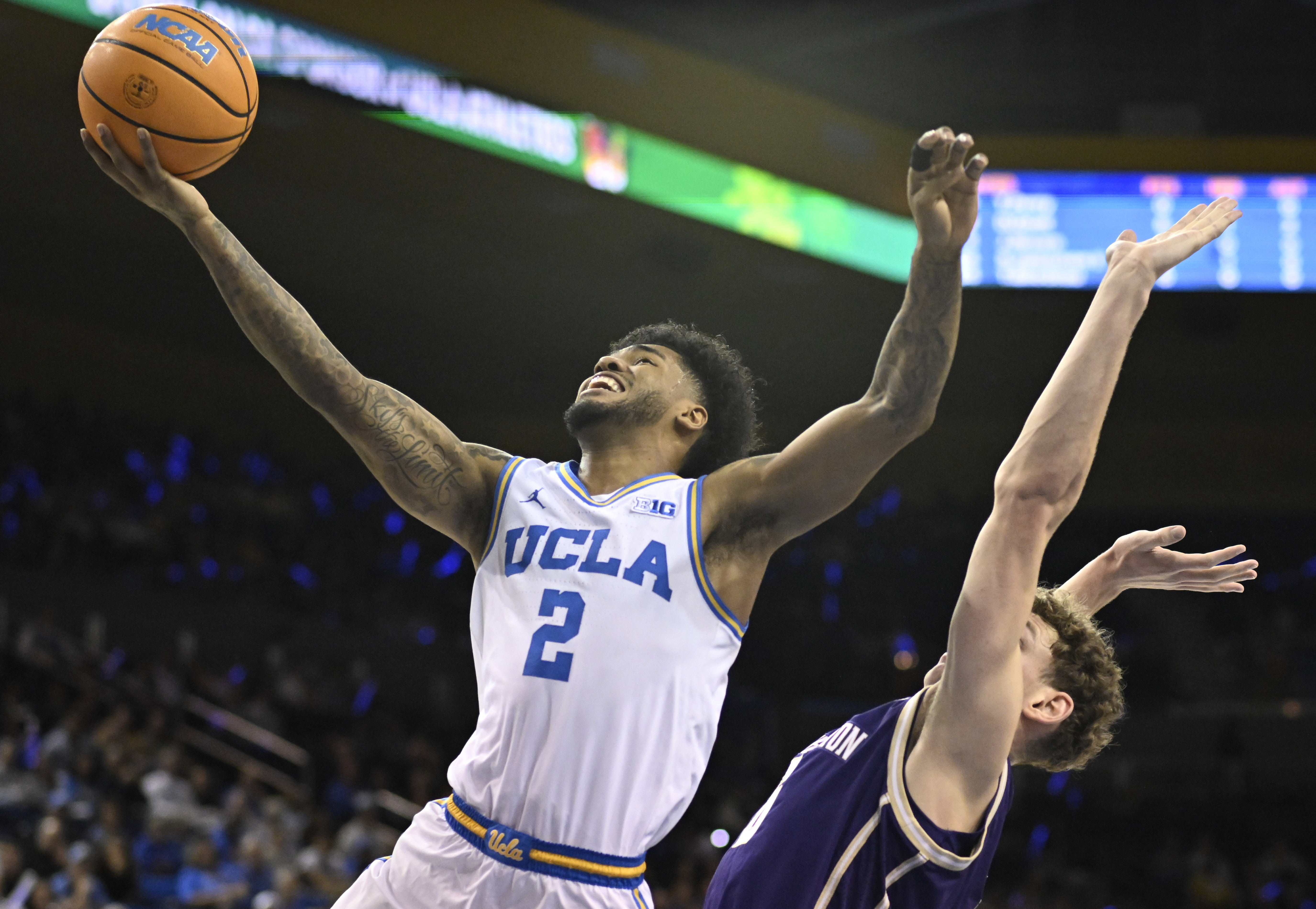 Guard Donovan Dent #2 of the UCLA Bruins drives to...