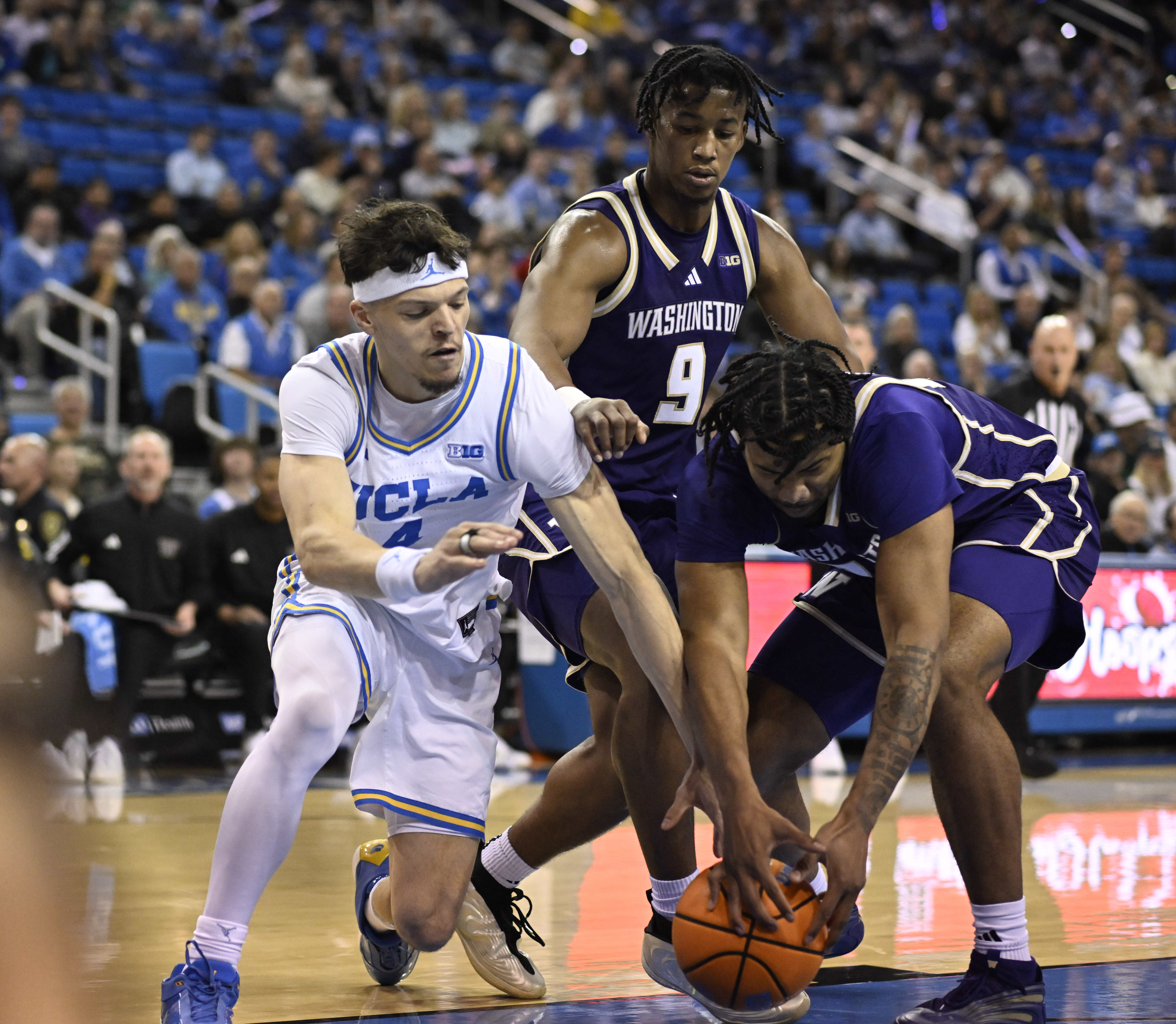 Guard Jamar Brown #4 of the UCLA Bruins scrambles for...
