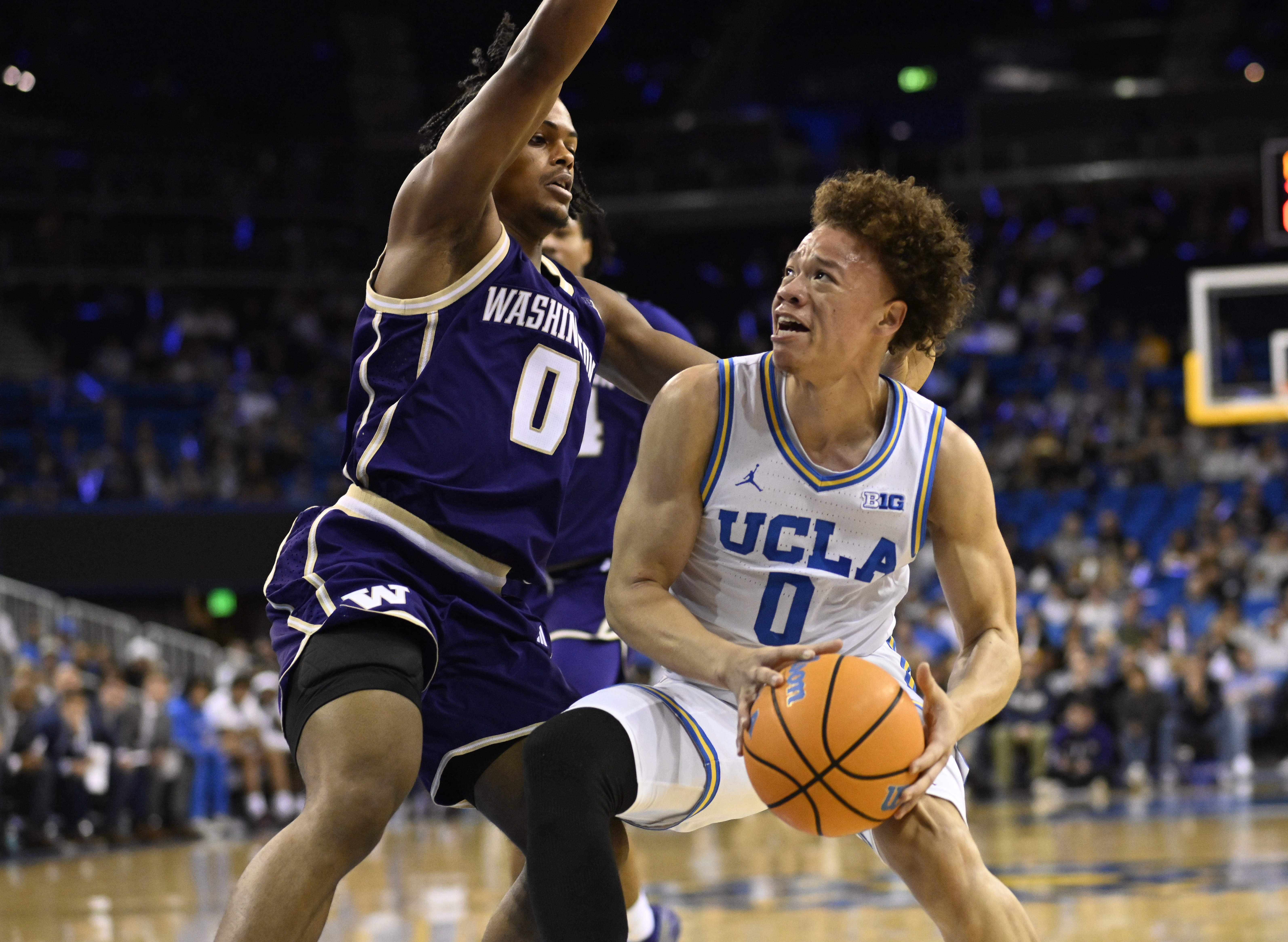 Guard Trent Perry #0 of the UCLA Bruins drives to...