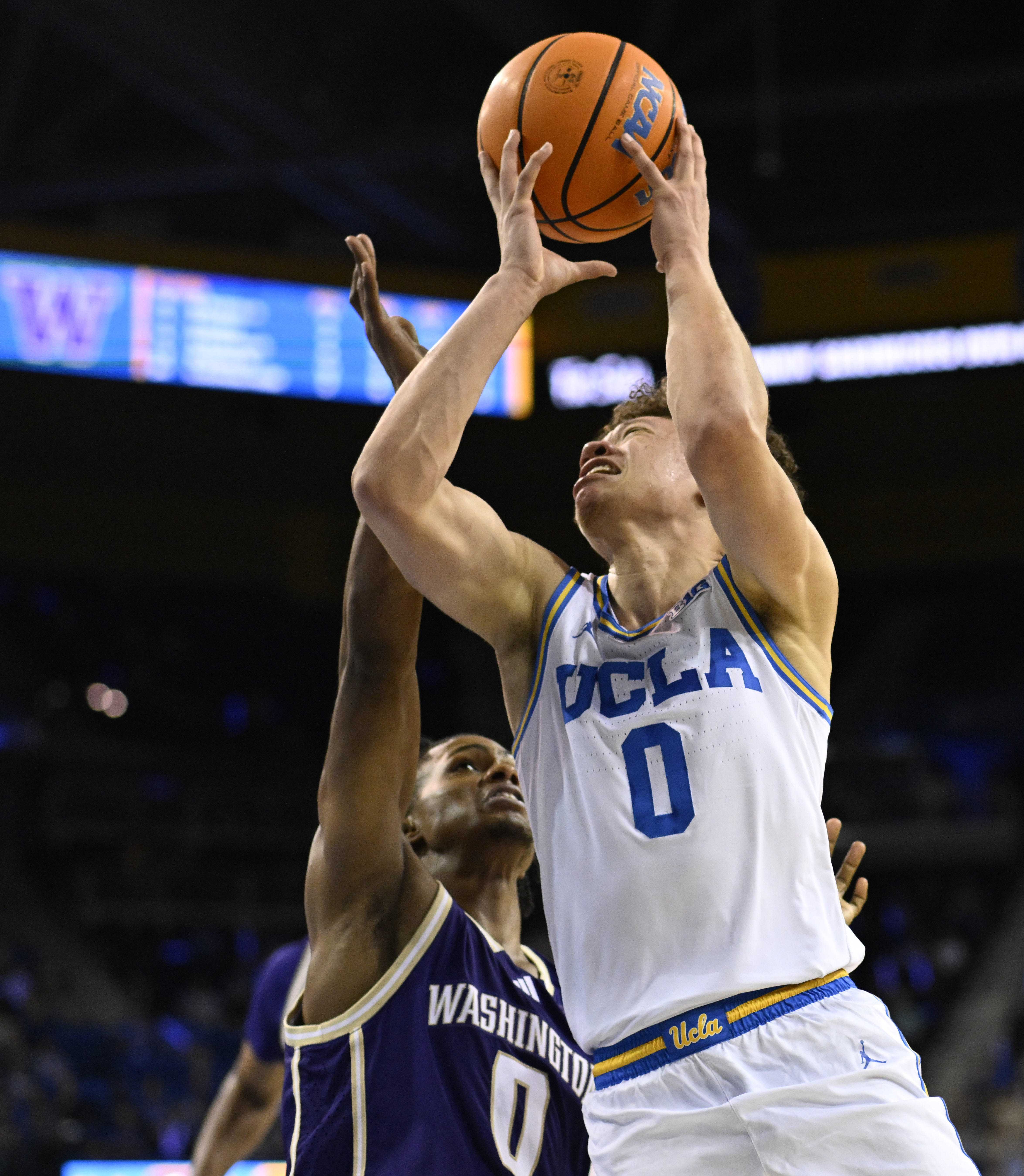 Guard Trent Perry #0 of the UCLA Bruins drives to...