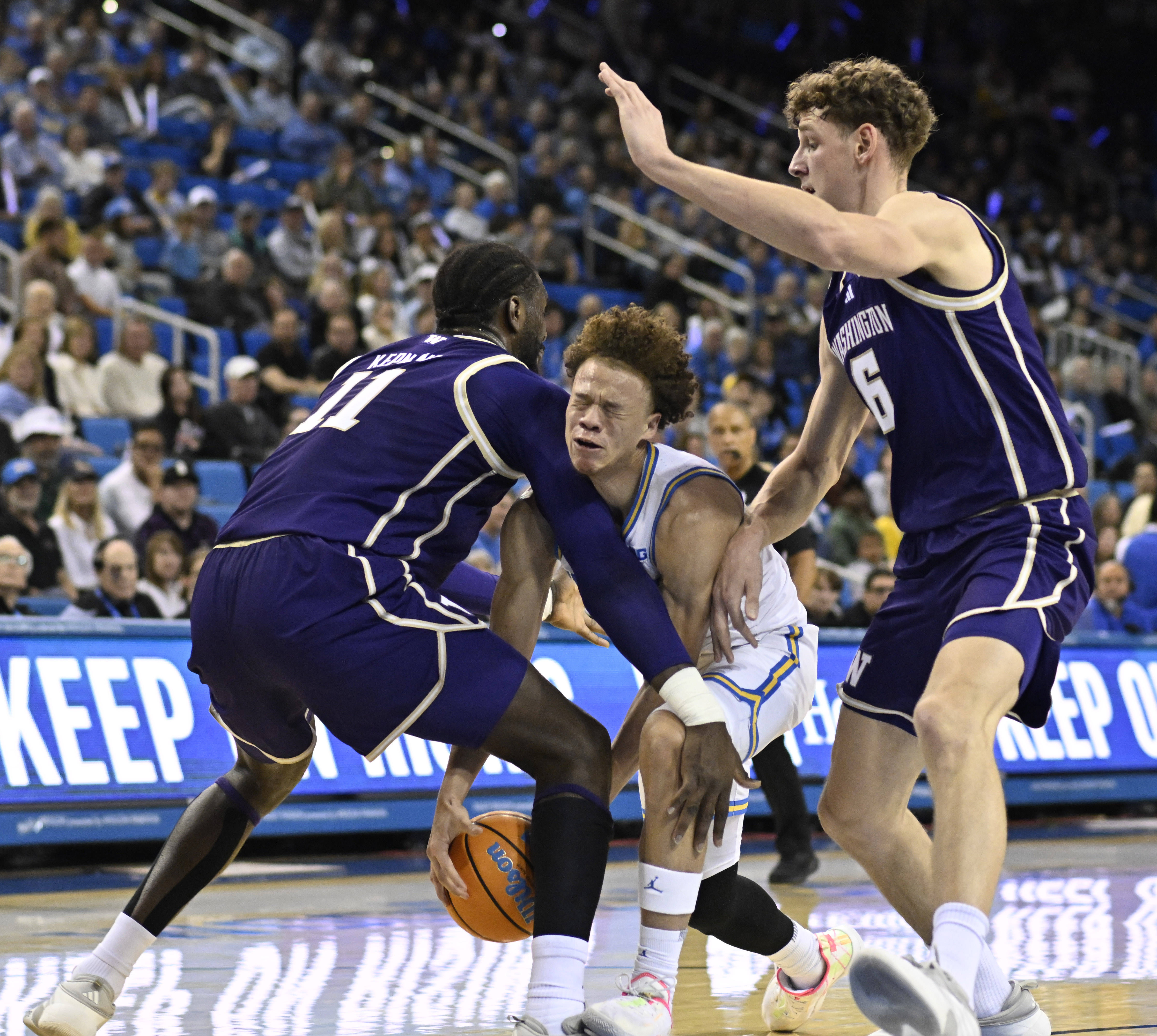 Guard Trent Perry #0 of the UCLA Bruins drives to...