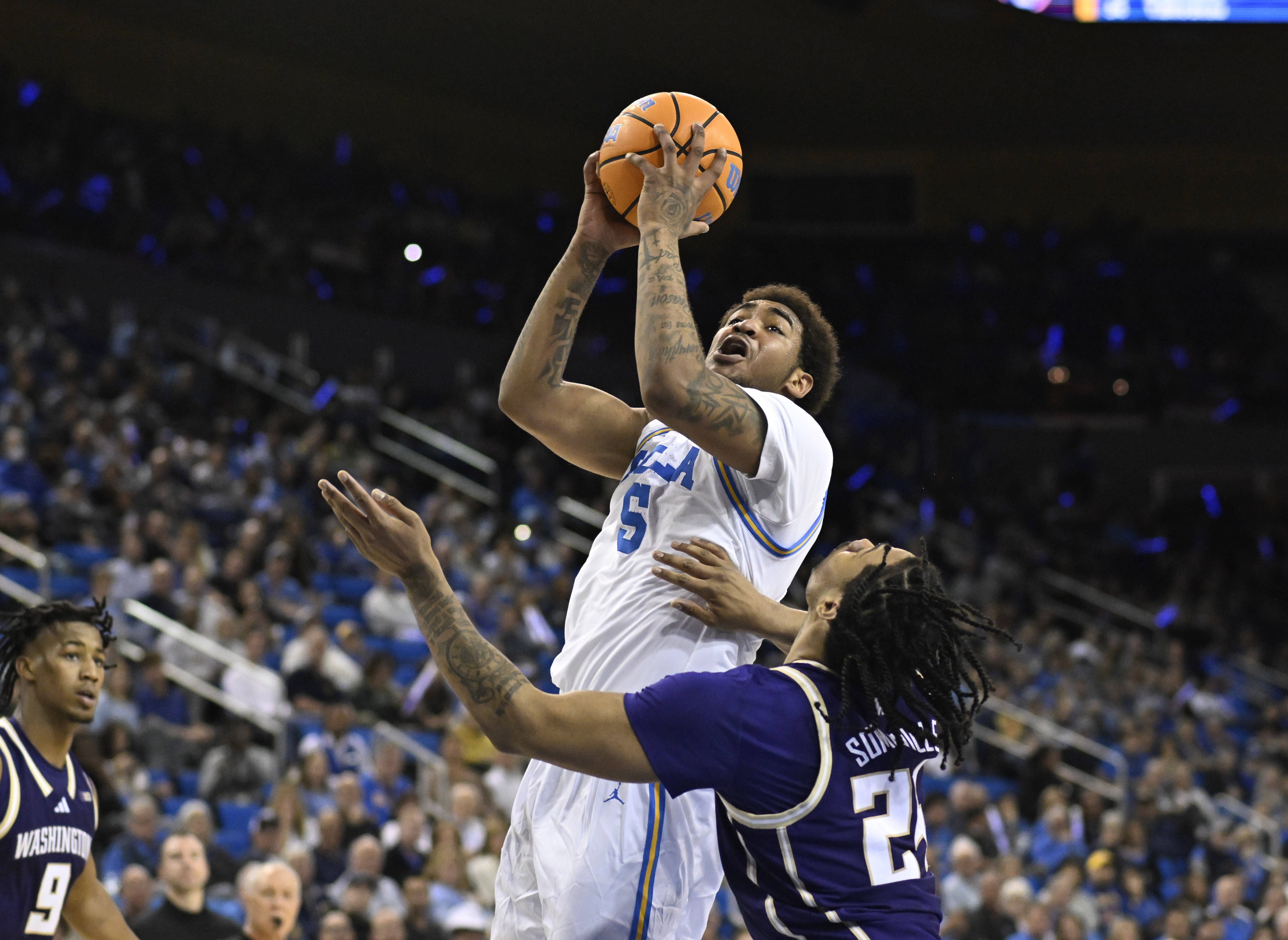 Guard Brandon Williams #5 of the UCLA Bruins drives to...
