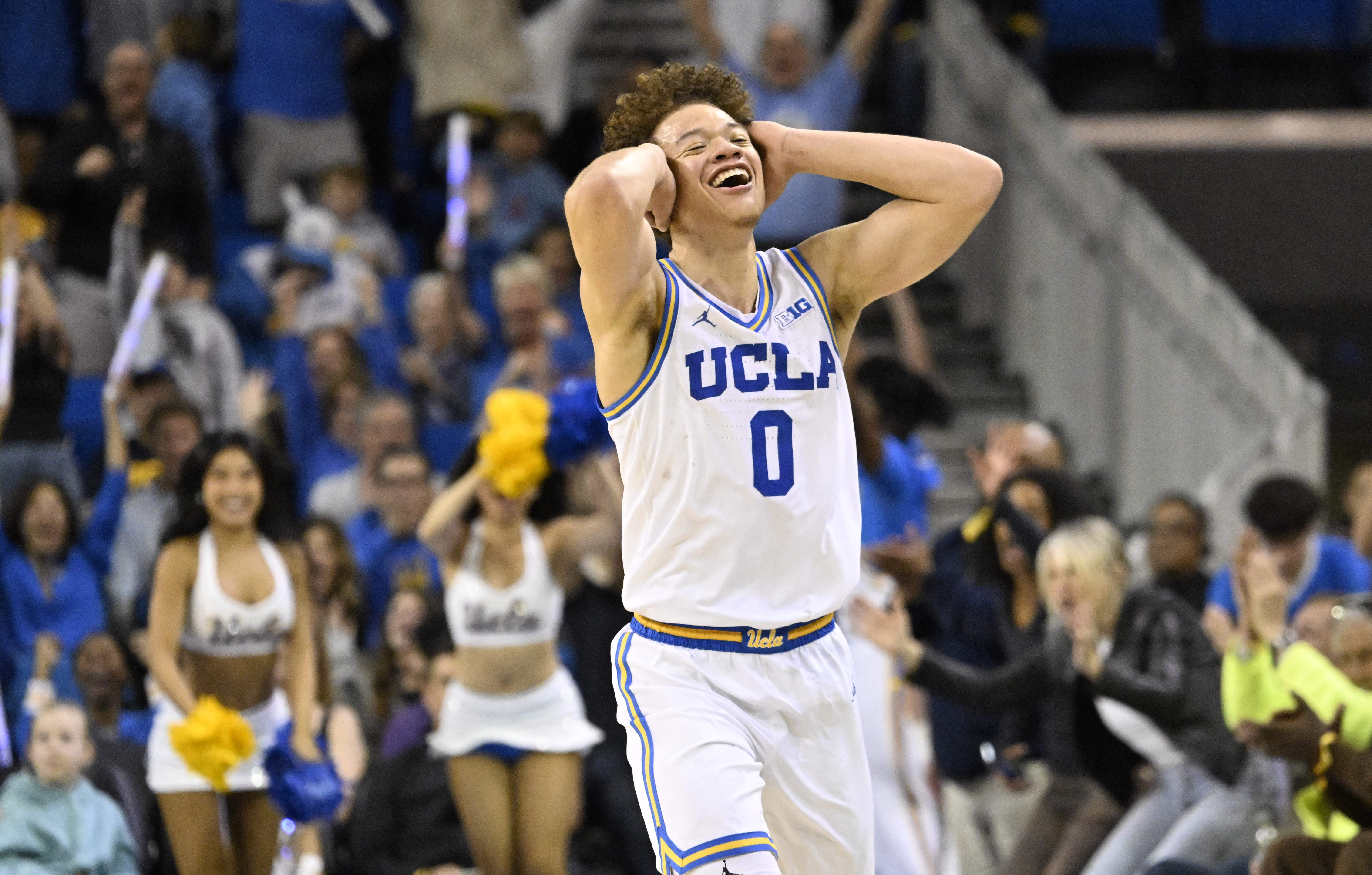 Guard Trent Perry #0 of the UCLA Bruins reacts after...