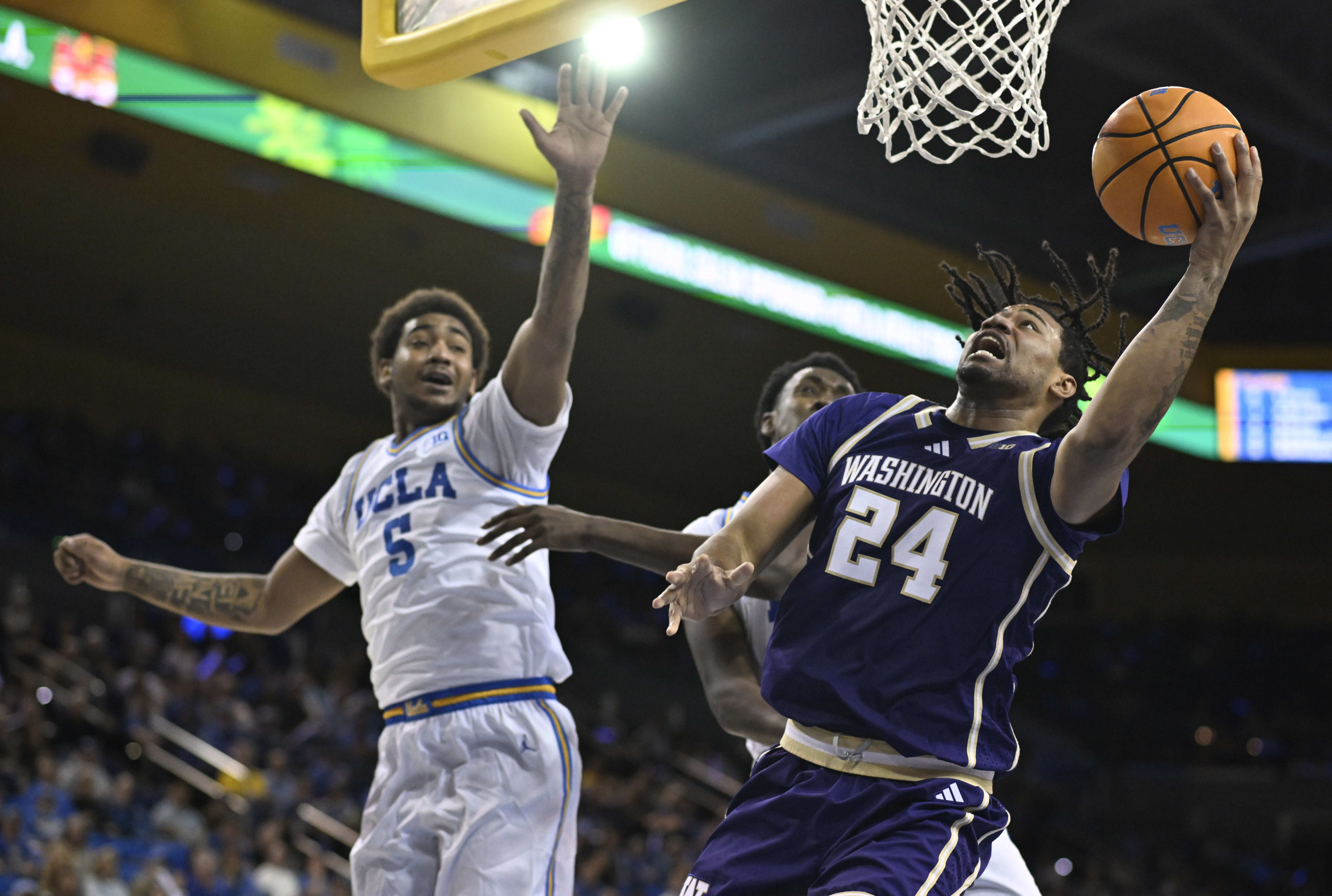 Center Lathan Sommerville #24 of the Washington Huskies drives to...