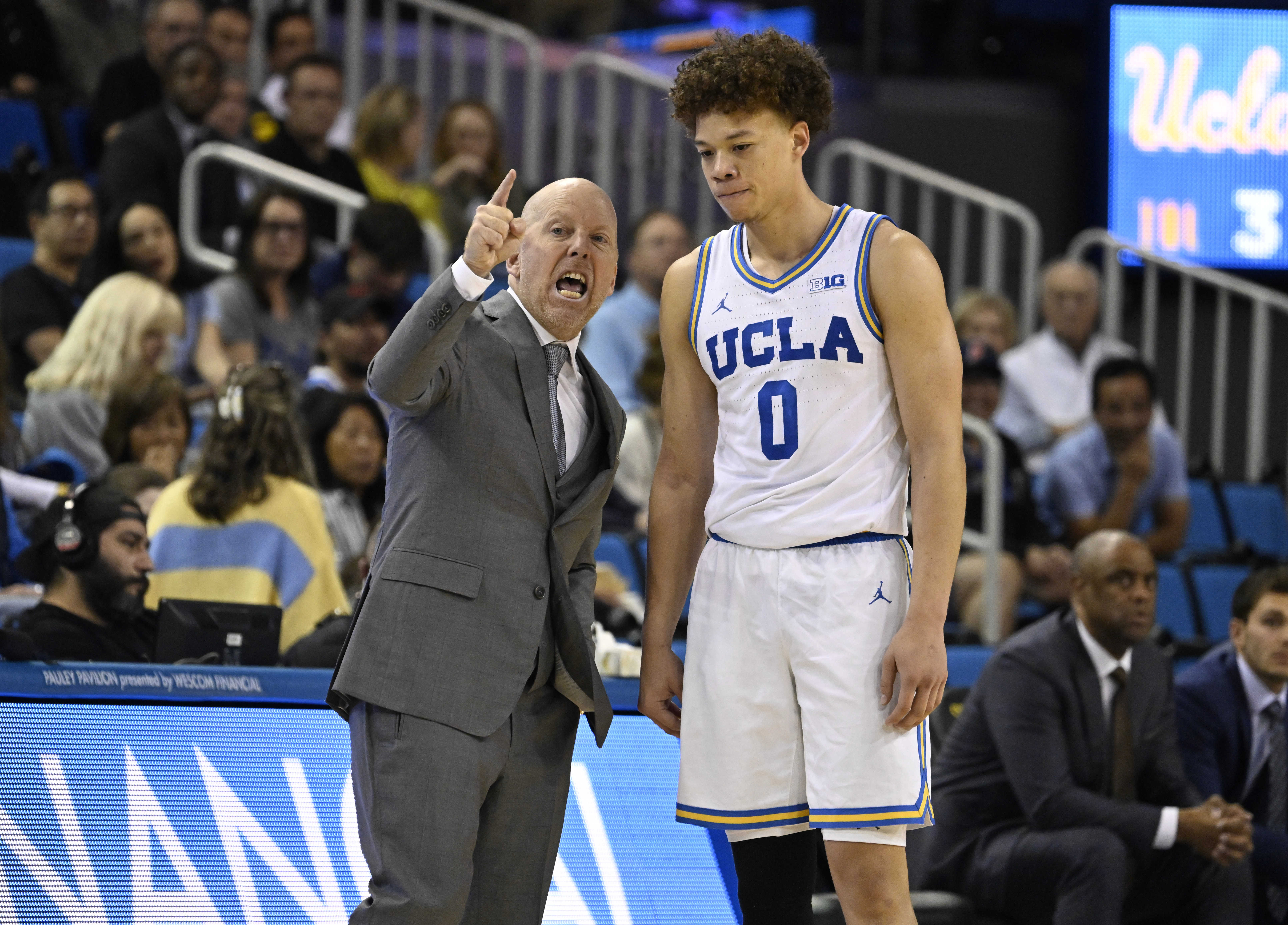 Head coach Mick Cronin of the UCLA Bruins talks with...
