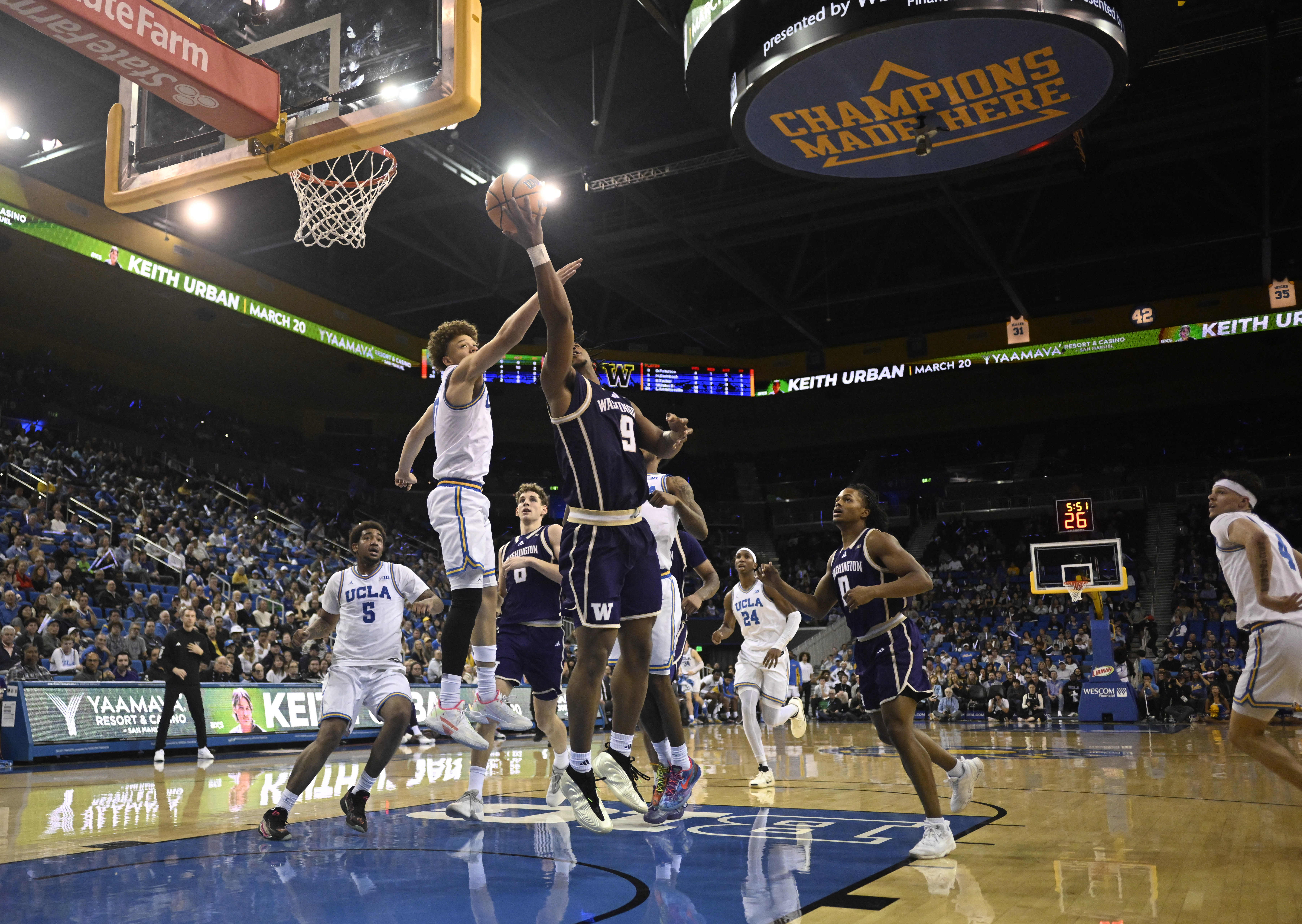 Guard Wesley Yates III #9 of the Washington Huskies drives...