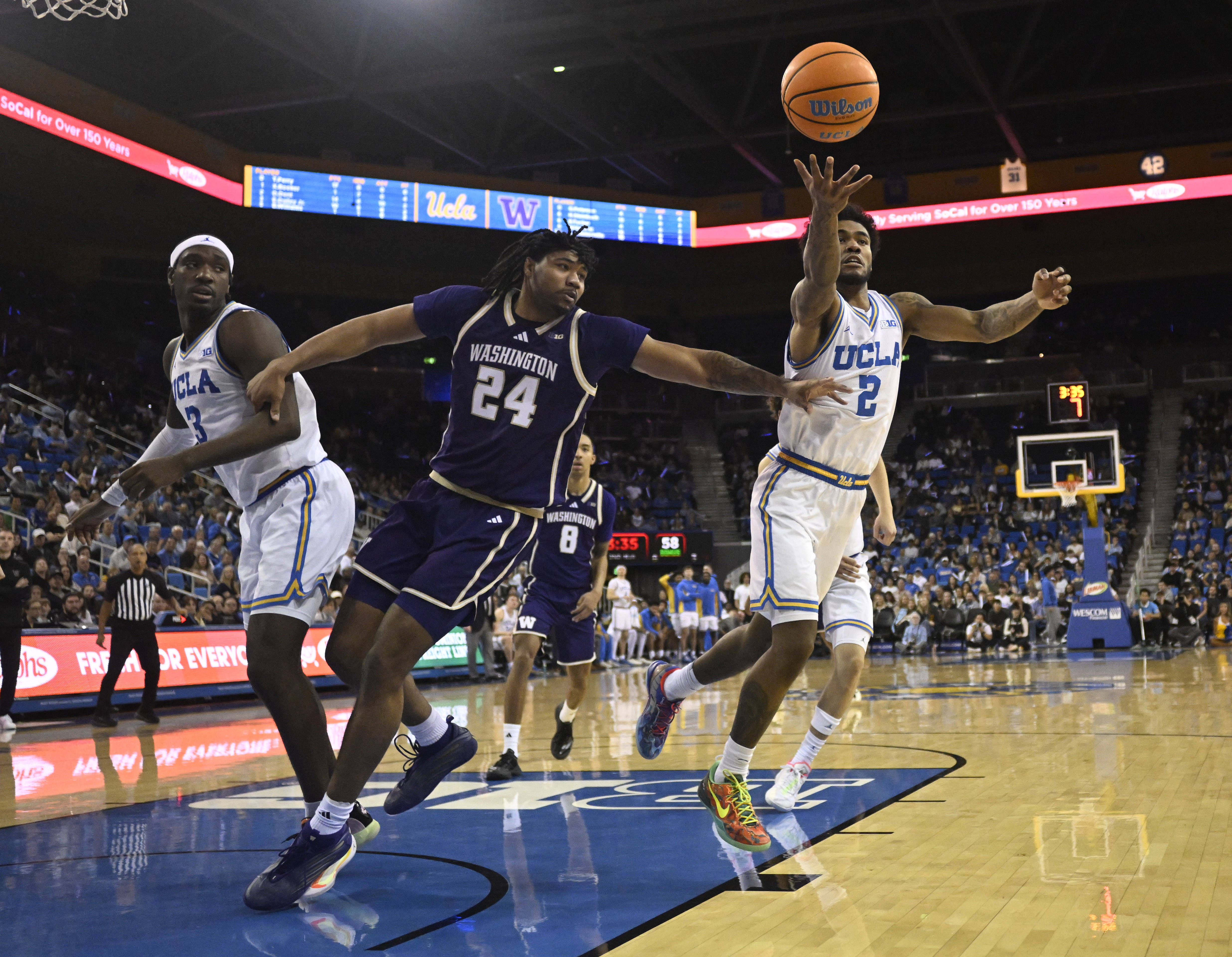 Guard Donovan Dent #2 of the UCLA Bruins reaches for...