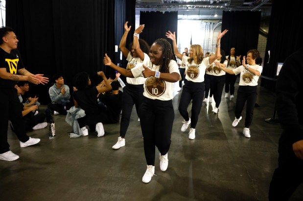 The Hardwood Classics, the senior dance team for the Golden State Warriors, head to the court as they are encouraged by other performers before their performance before the start of the fourth quarter during the game between the Utah Jazz and the Golden State Warriors at the Chase Center in San Francisco, Calif., on Monday, Nov. 24, 2025. (Nhat V. Meyer/Bay Area News Group)