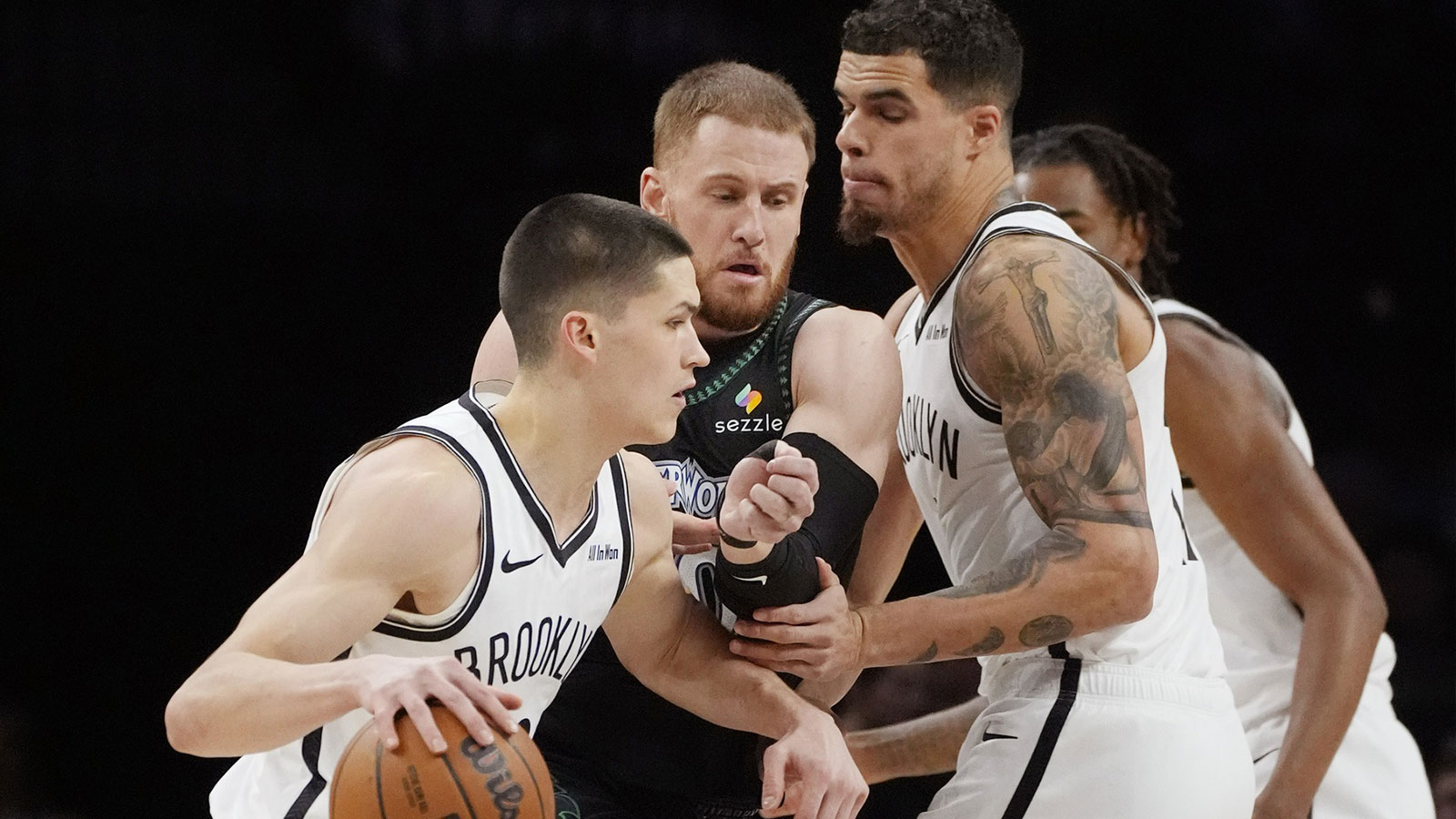 Brooklyn Nets forward Michael Porter Jr. (17) sets a pick against Minnesota Timberwolves guard Donte DiVincenzo (0) in order for Brooklyn Nets guard Egor Demin (8) to get by in the first quarter at Target Center.
