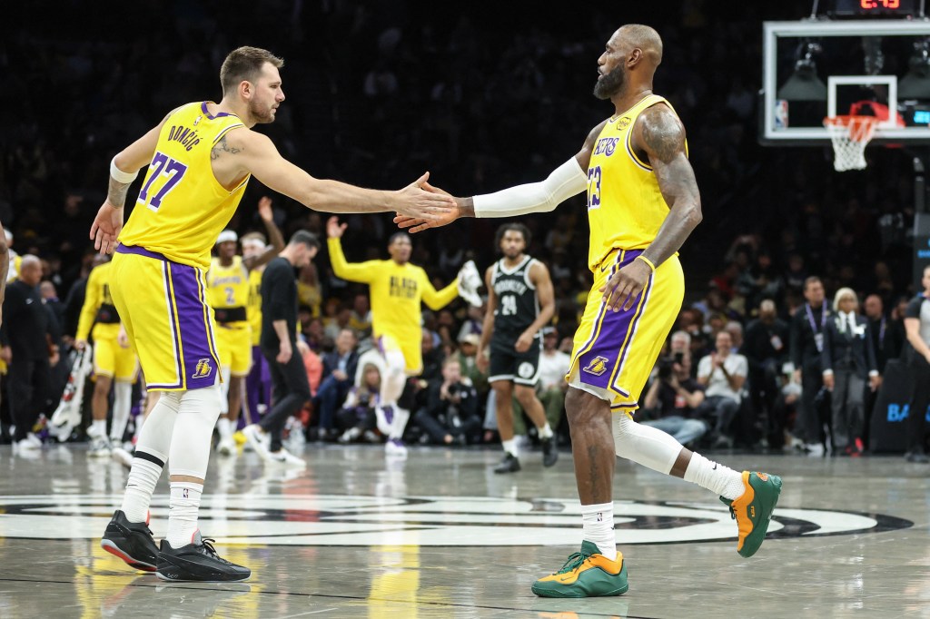 Luka Doncic and LeBron James shake hands during the NBA game between the Los Angeles Lakers and the Brooklyn Nets.