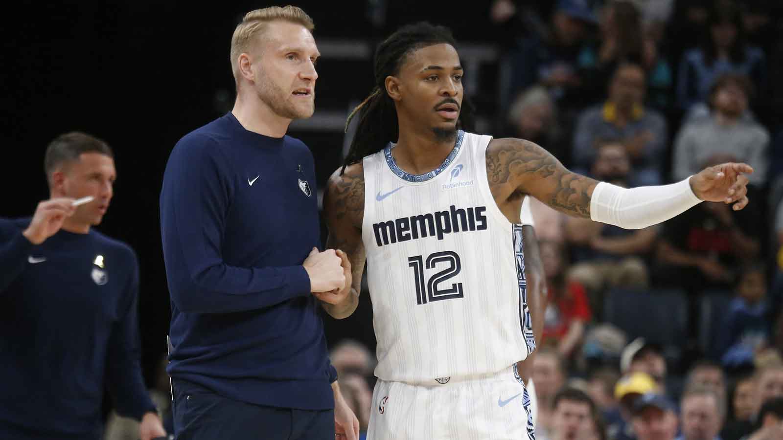 Memphis Grizzlies head coach Tuomas Iisalo talks with guard Ja Morant (12) during the fourth quarter against the Milwaukee Bucks at FedExForum.
