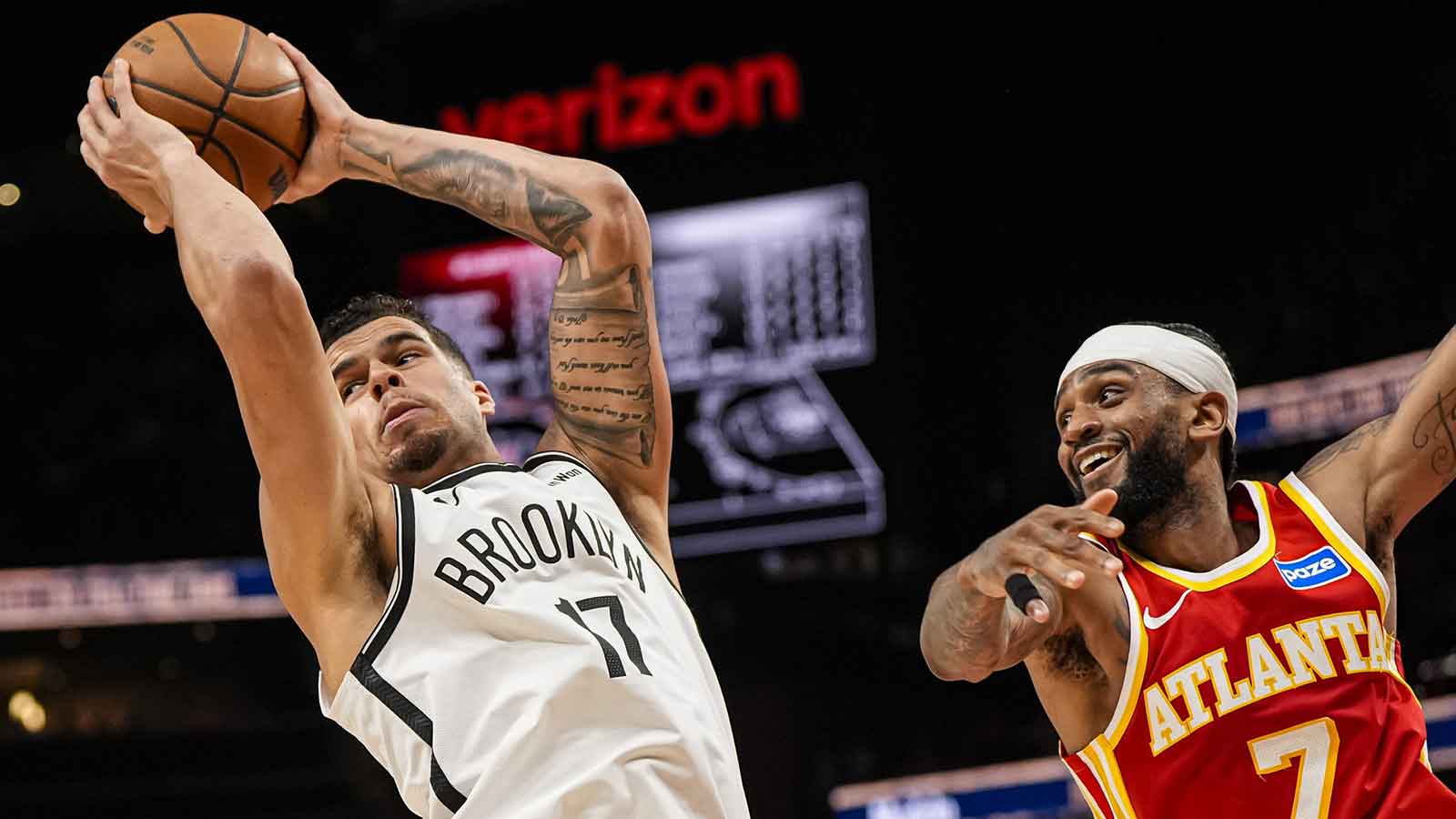 Brooklyn Nets forward Michael Porter Jr. (17) grabs a rebound over Atlanta Hawks guard Nickeil Alexander-Walker (7) during the second half at State Farm Arena.