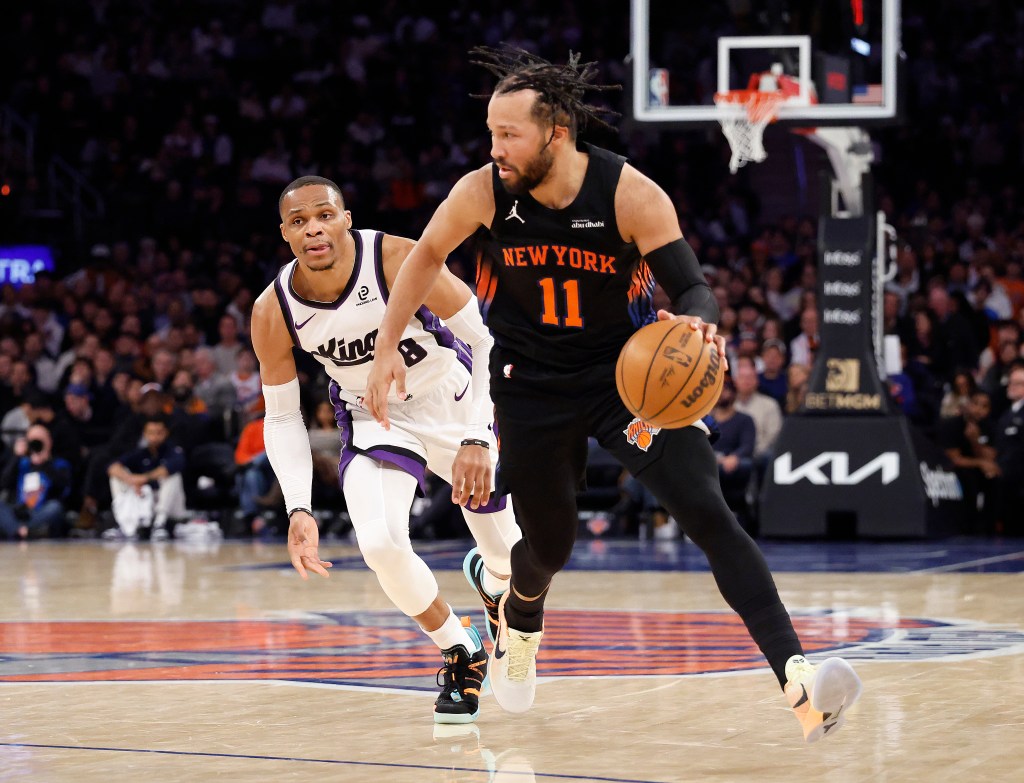 New York Knicks guard Jalen Brunson drives down court as Sacramento Kings guard Russell Westbrook gives chase.