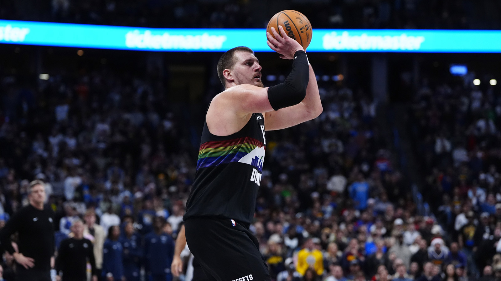 Denver Nuggets center Nikola Jokic (15) lines up a successful three point basket in overtime against the Minnesota Timberwolves at Ball Arena.