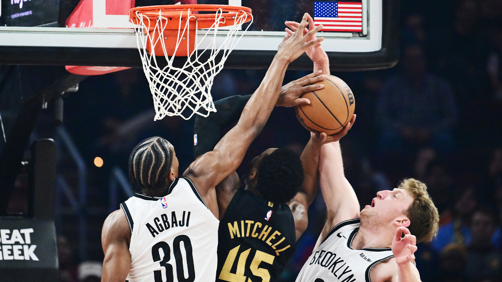 Cleveland Cavaliers guard Donovan Mitchell (45) drives to the basket between Brooklyn Nets guard Ochai Agbaji (30) and forward Danny Wolf (2) during the first half at Rocket Arena.