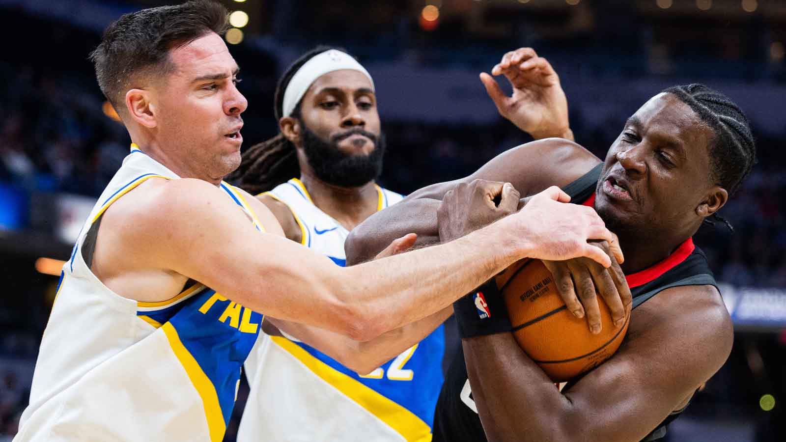 Indiana Pacers guard T.J. McConnell (9) and Houston Rockets center Clint Capela (30) fight for the ball in the first half at Gainbridge Fieldhouse.