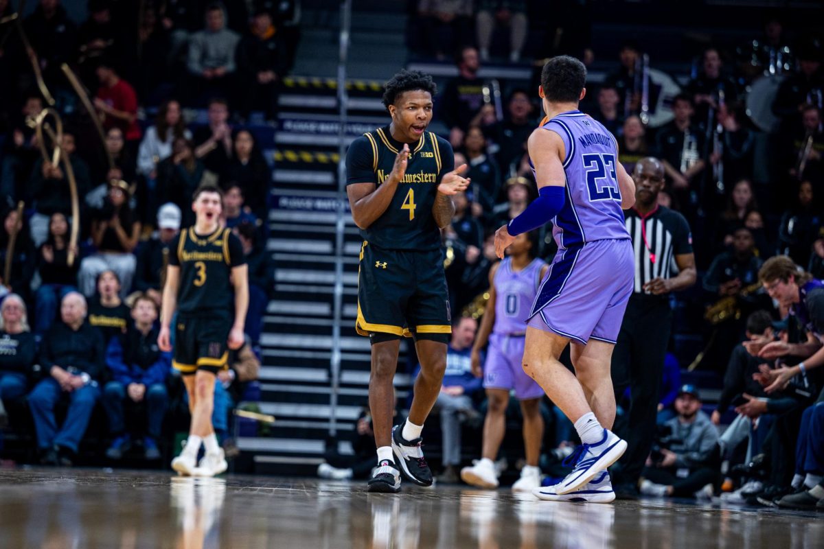 A Northwestern player in a black jersey claps their hands.