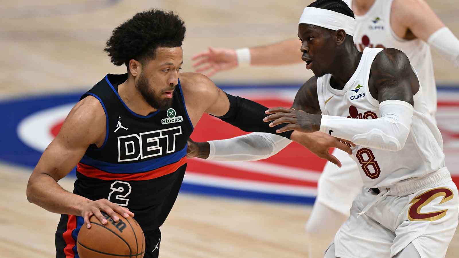 Detroit Pistons guard Cade Cunningham (2) tries to drive past Cleveland Cavaliers guard Dennis Schroder (8) in the first half at Little Caesars Arena.