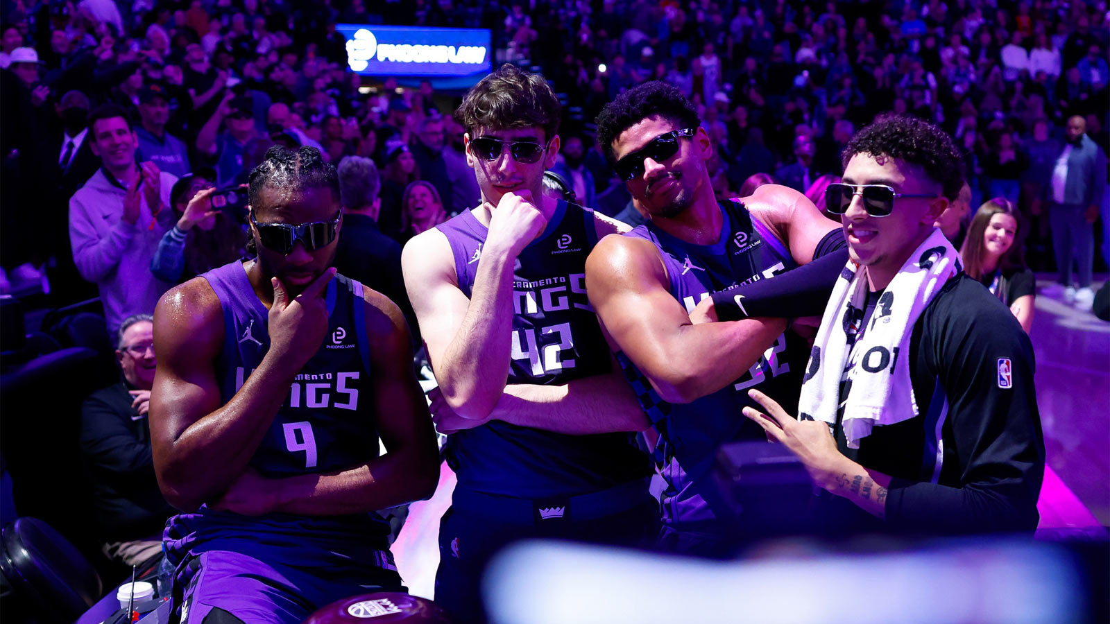 Sacramento Kings forward Precious Achiuwa (9) and center Maxime Raynaud (42) and center Dylan Cardwell (32) and guard Nique Clifford (5) celebrate after lighting the beam in celebration of their victory against the Washington Wizards at Golden 1 Center.