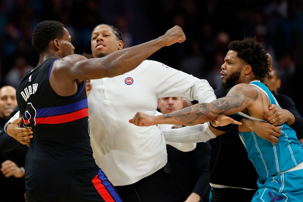 Detroit Pistons center Jalen Duren, left, throws punches with Charlotte Hornets forward Miles...