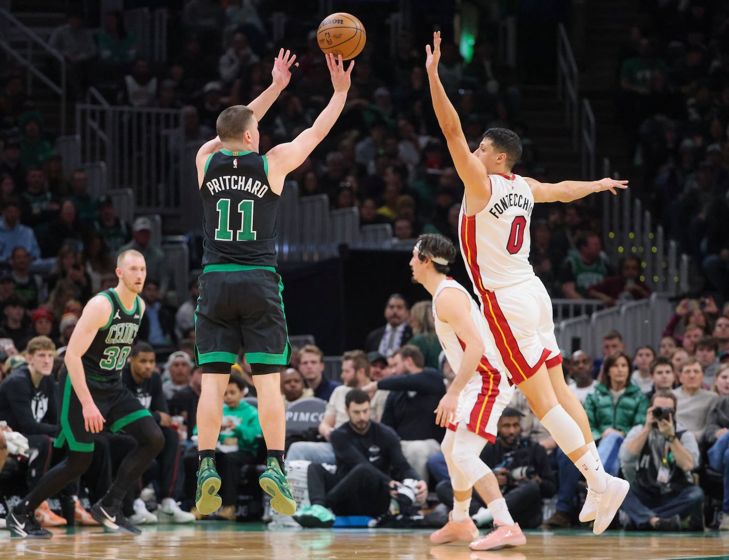 Payton Pritchard makes a 3-pointer over Miami's Simone Fontecchio during the third quarter.