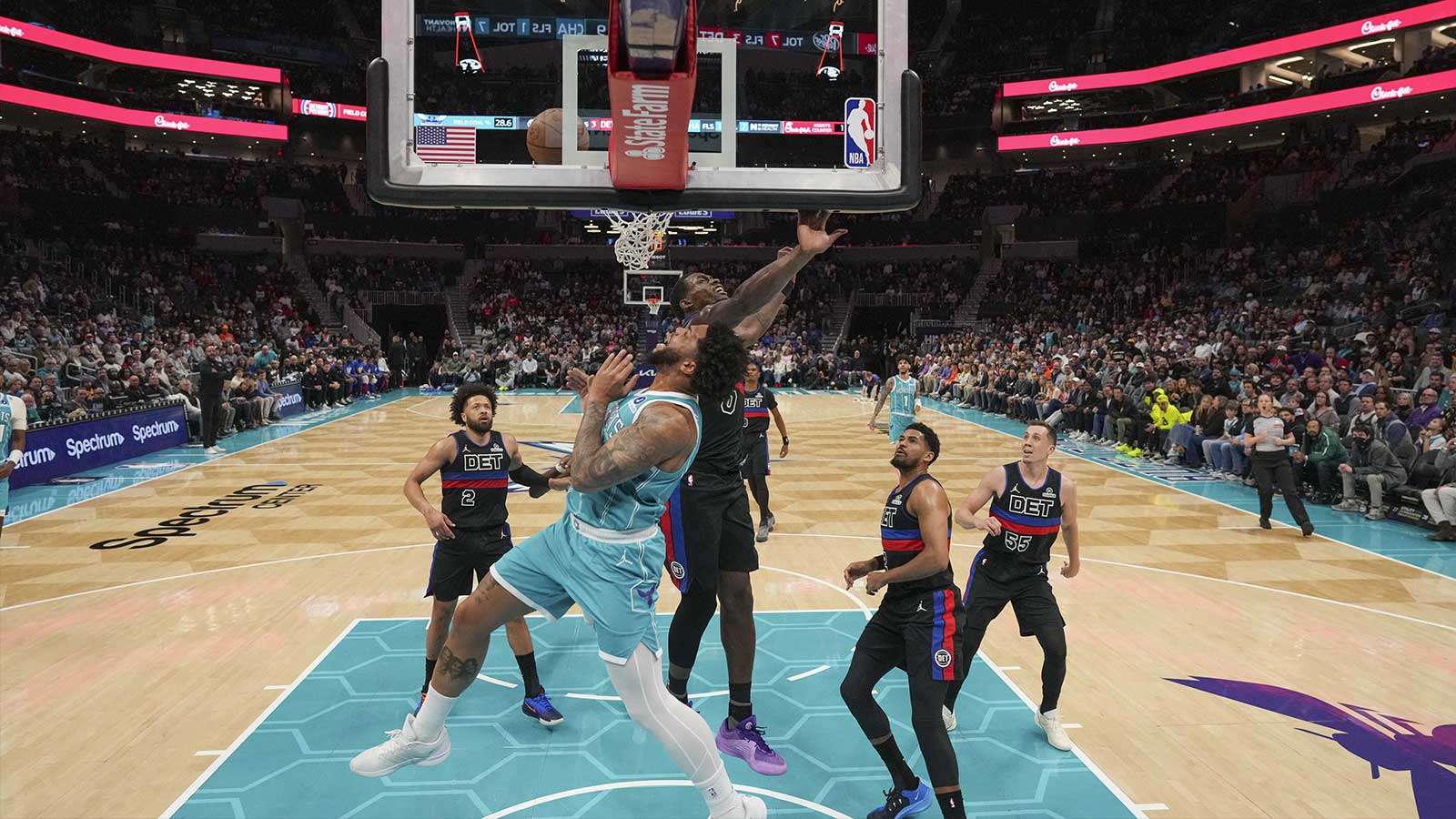 Charlotte Hornets forward Miles Bridges (0) and Detroit Pistons center Jalen Duren (0) collide at the rim during the second half at Spectrum Center.