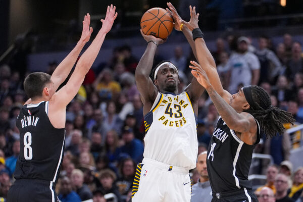 Indiana Pacers forward Pascal Siakam (43) shoots between Brooklyn Nets guard Egor Demin (8) and forward Terance Mann (14) during the second half of an NBA basketball game in Indianapolis, Wednesday, Nov. 5, 2025. (AP Photo/Michael Conroy)